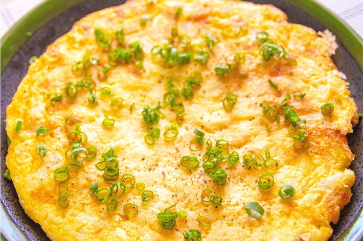 長芋チーズ焼きが皿に盛られ、美しくネギが散らされています。
