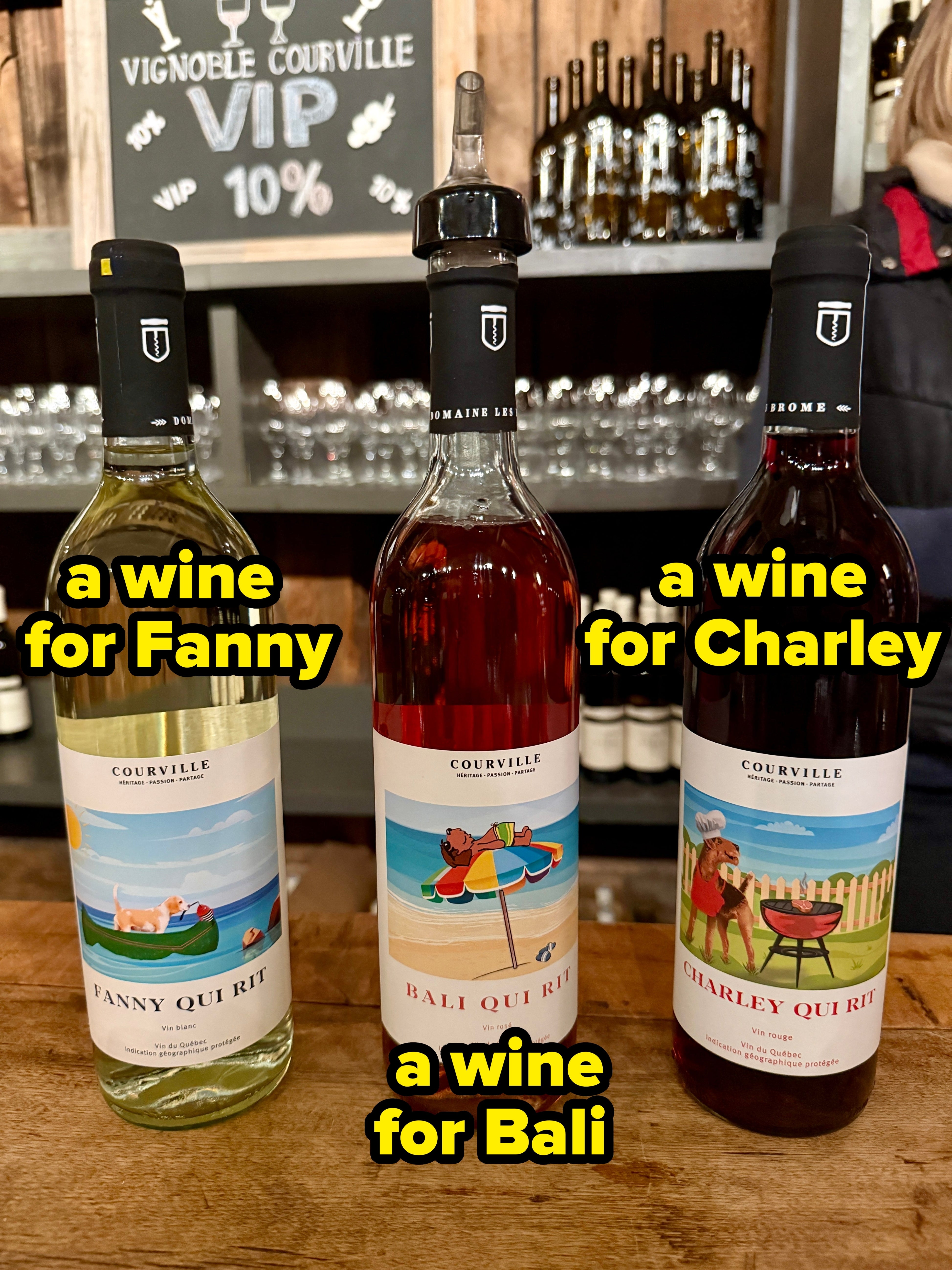 Three bottles of Courville vino with illustrated labels are displayed connected a counter. Each statement features a antithetic whimsical scene
