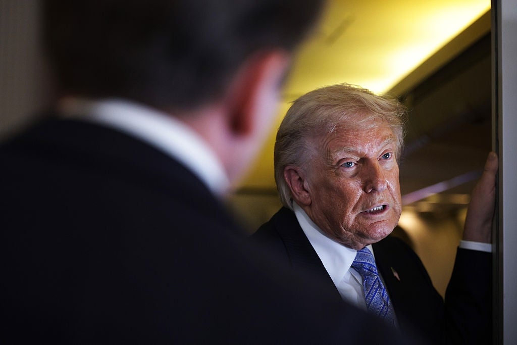 Man with suit   and tie, speaking intensely to different  person, indoors