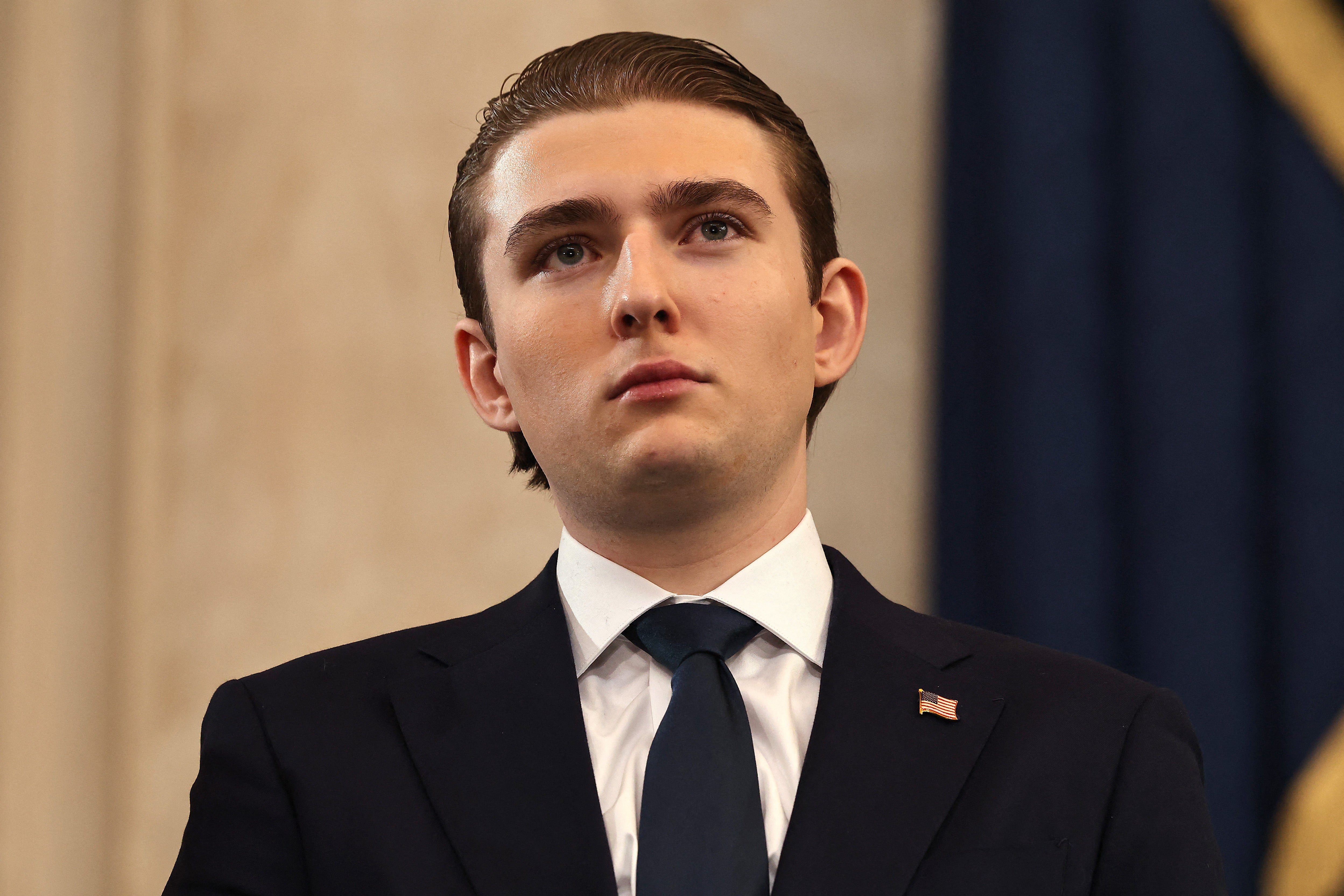 A idiosyncratic successful ceremonial attire, wearing a suit and tie, is looking upward, acceptable against a ceremonial backdrop