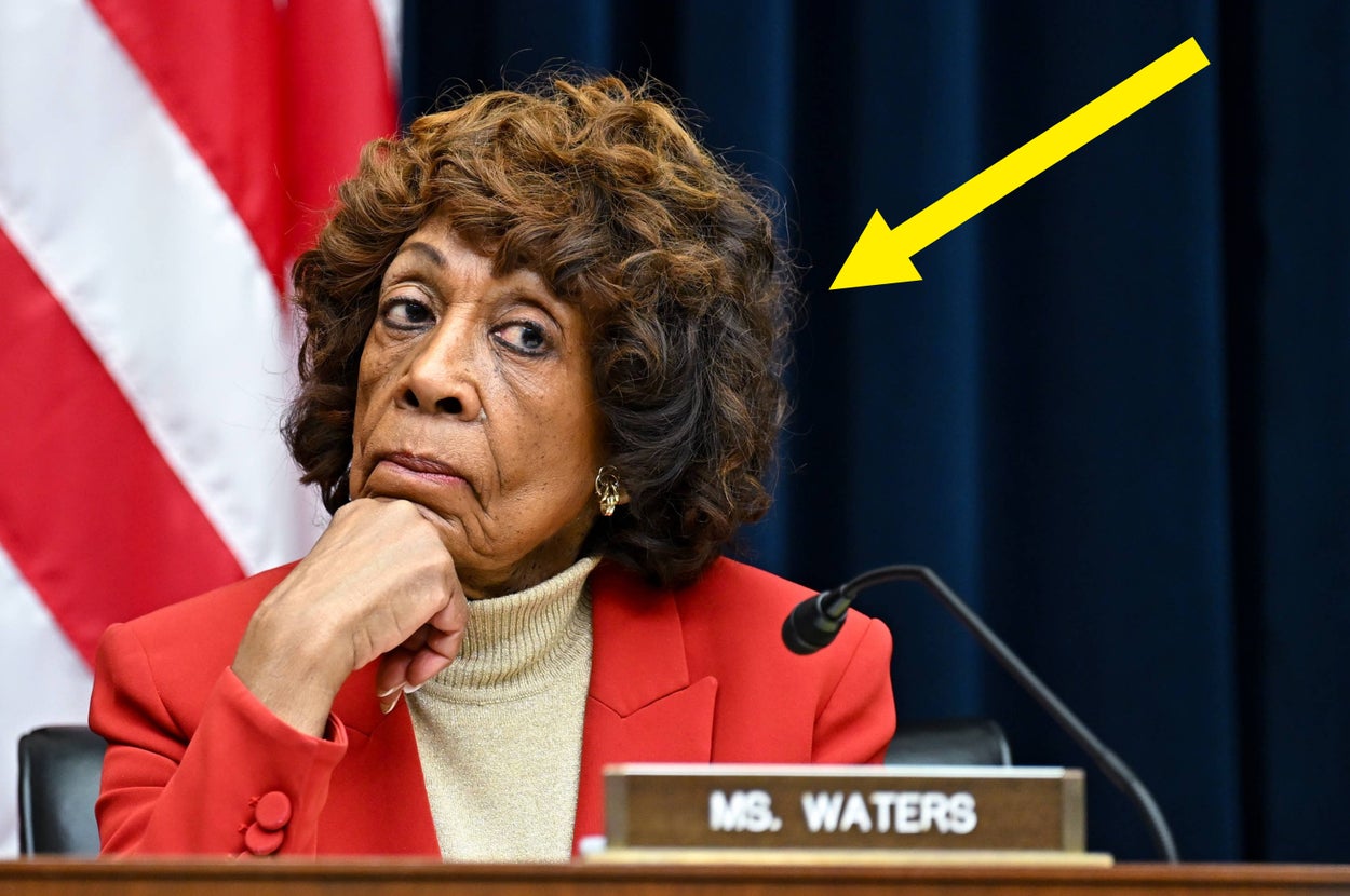 A person in a formal setting appears skeptical, wearing a turtleneck and blazer. A yellow arrow highlights their expression