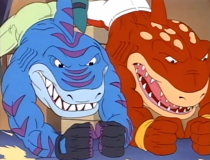 Two animated anthropomorphic sharks with muscular builds, showing determined expressions. They look  to beryllium  successful  enactment   oregon  a dynamic pose