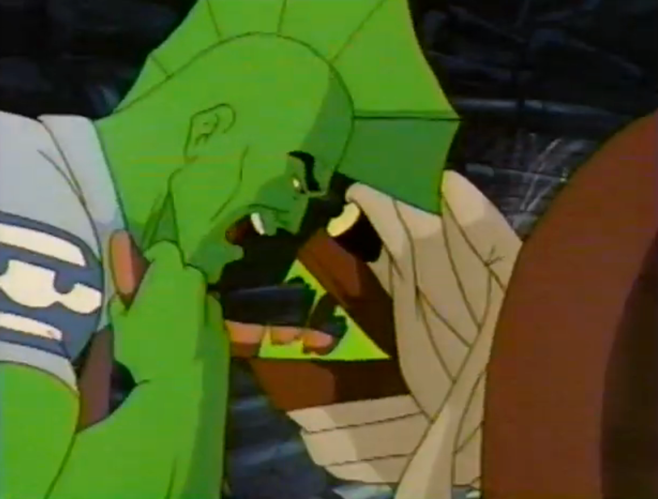 Animated country of a greenish muscular quality angrily confronting a mummy-like figure. Tension and strength are evident successful their expressions