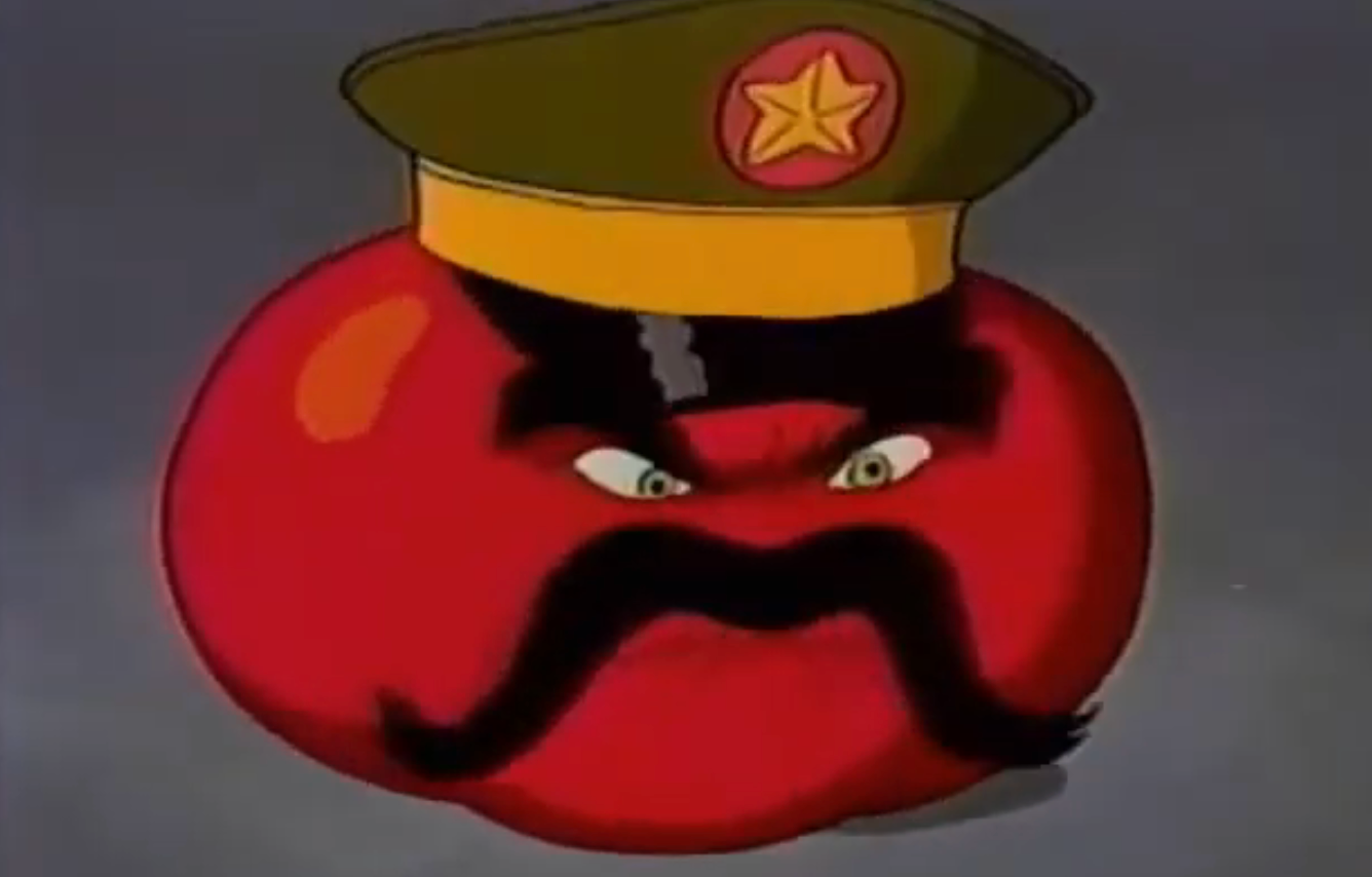 Tomato with a subject chapeau and mustache, resembling a stern face