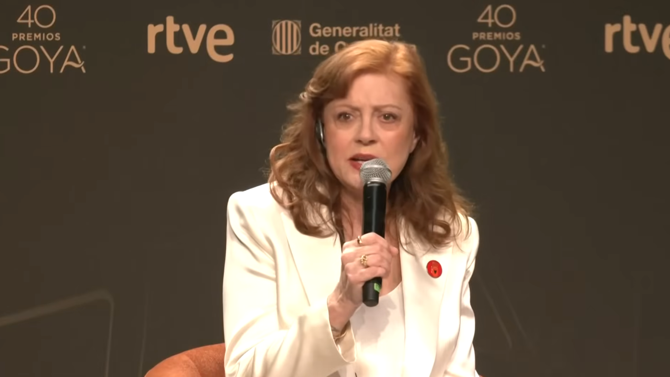Person som taler ved det 40. Goya Awards-arrangementet. De har på seg et hvitt antrekk og holder en mikrofon