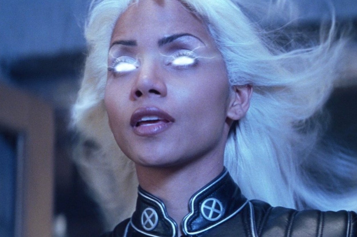 Halle Berry as Storm in "X-Men" with glowing eyes and white hair, wearing a leather uniform