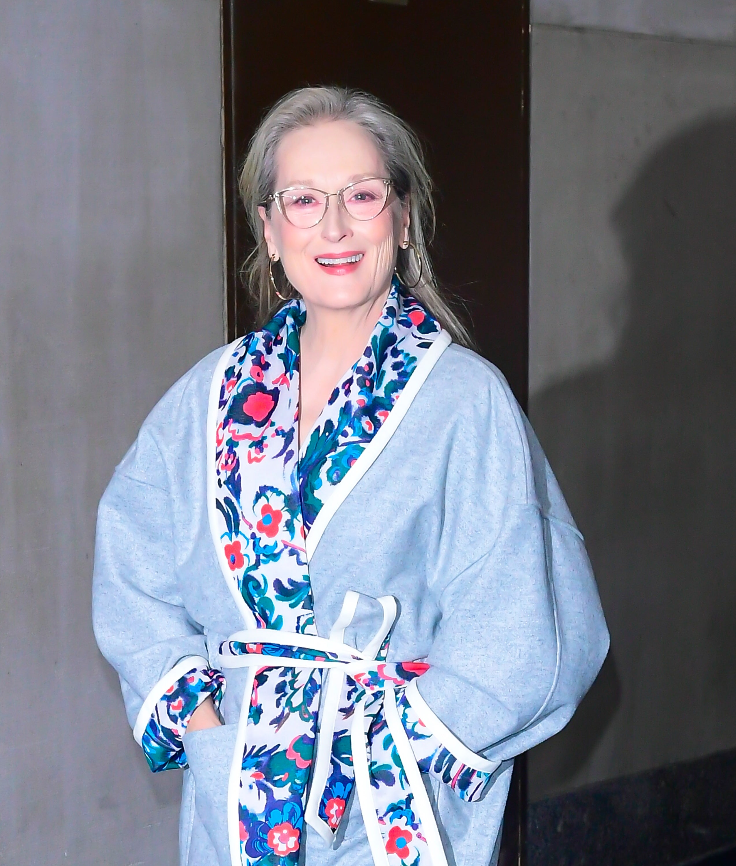 Meryl Streep smiling in a floral coat
