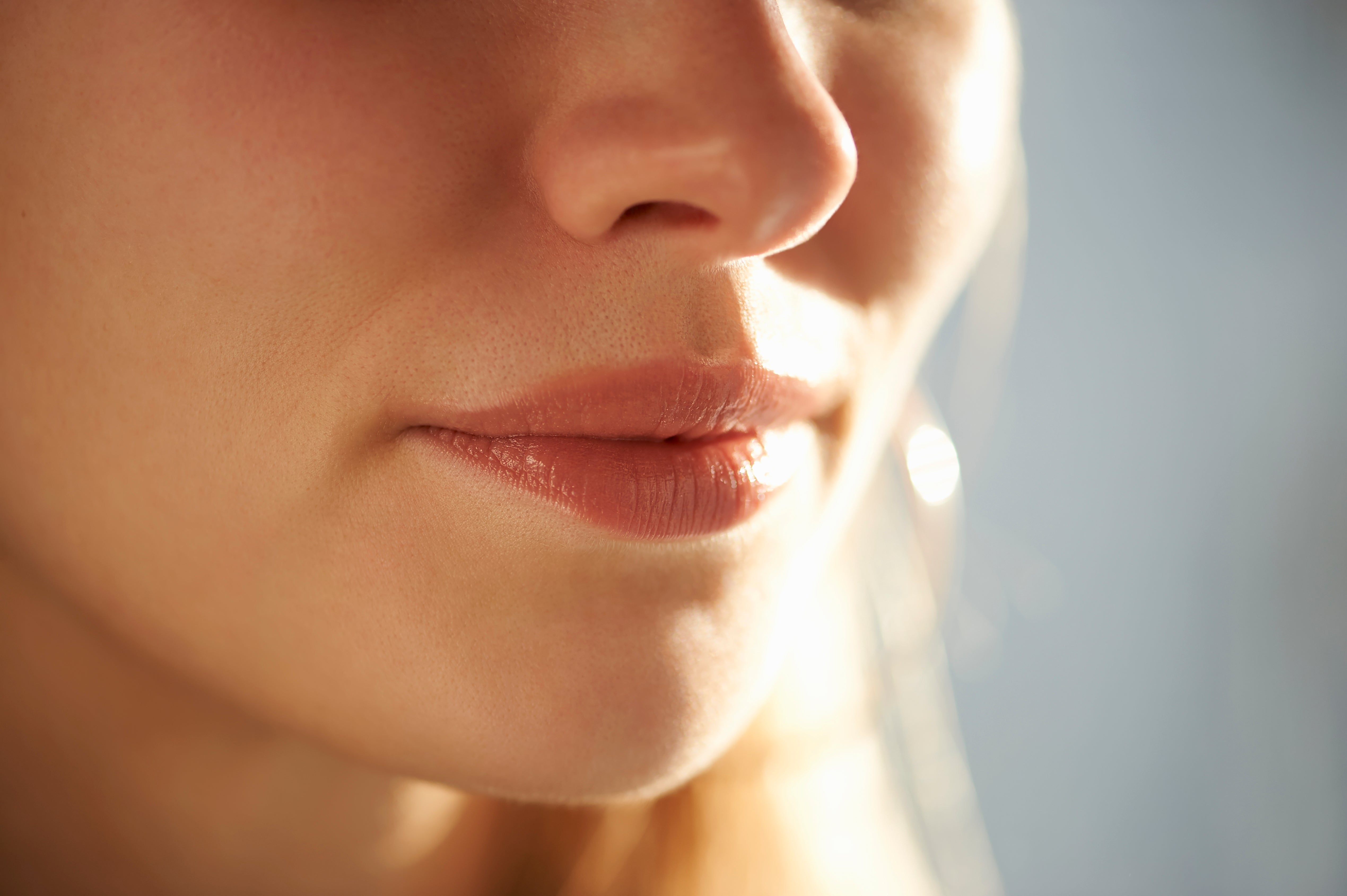 Close-up of a person's rima and little face, showing creaseless tegument and somewhat parted lips