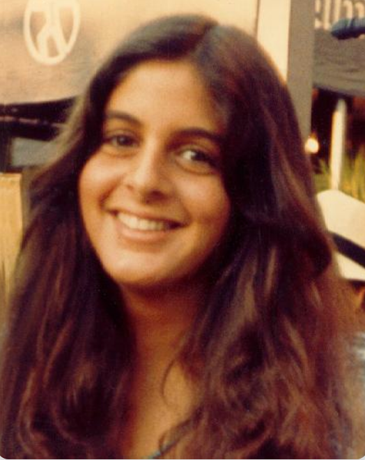 Smiling idiosyncratic   with agelong  hair, casually dressed, outdoors