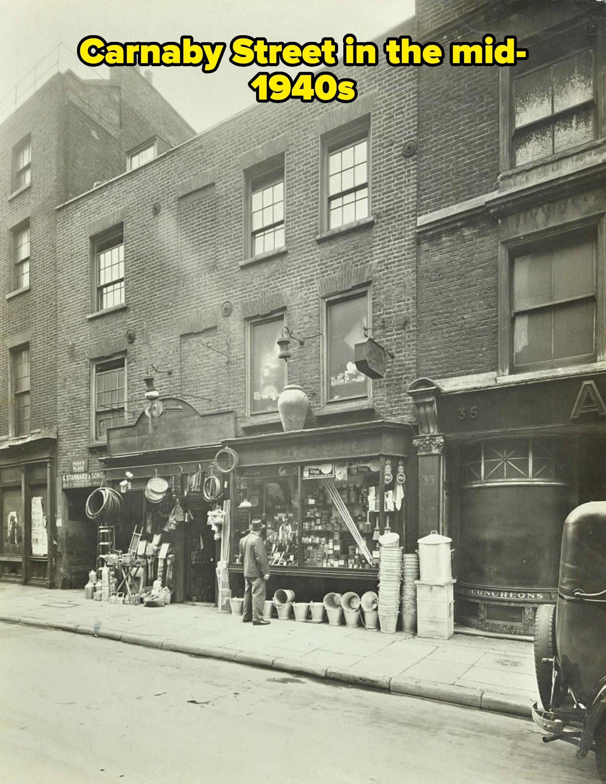 Vintage thoroughfare  country   with a historical  ceramic  storefront displaying assorted  household   goods connected  the sidewalk. A idiosyncratic   stands nearby