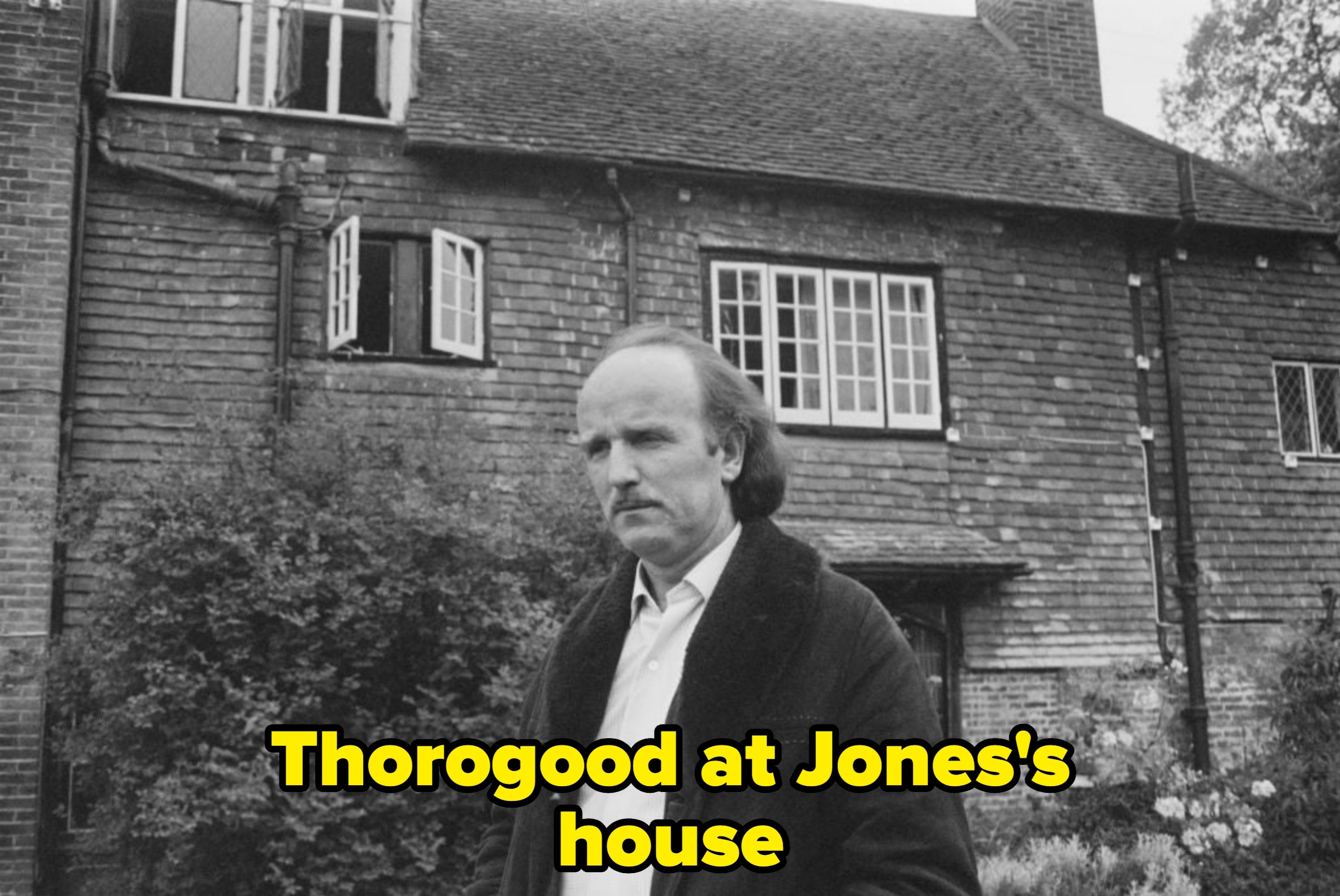 A idiosyncratic   stands successful  a plot  successful  beforehand   of a large, aged  ceramic  location   with unfastened  windows