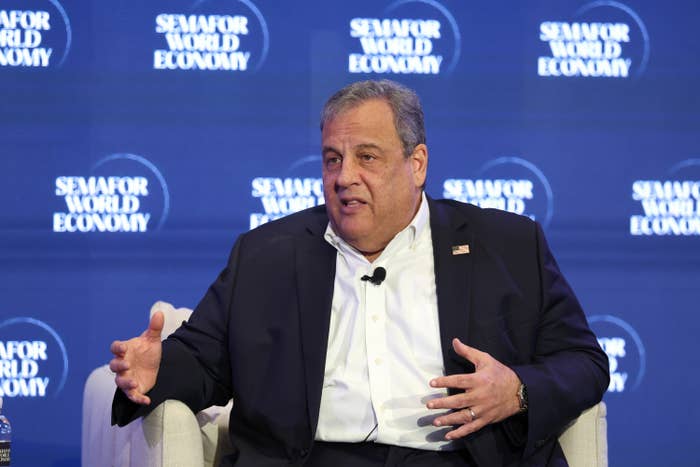 Person in a suit speaks on stage at a Semafor World Economy event