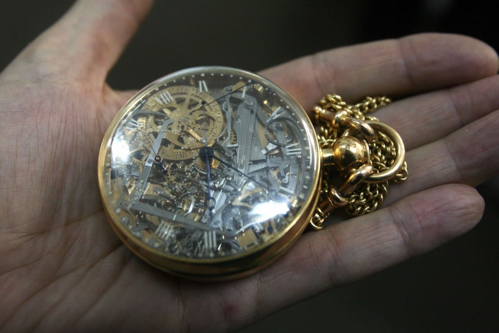 Intricately designed pouch  ticker  with disposable   interior   gears and Roman numerals, held successful  a person's hand