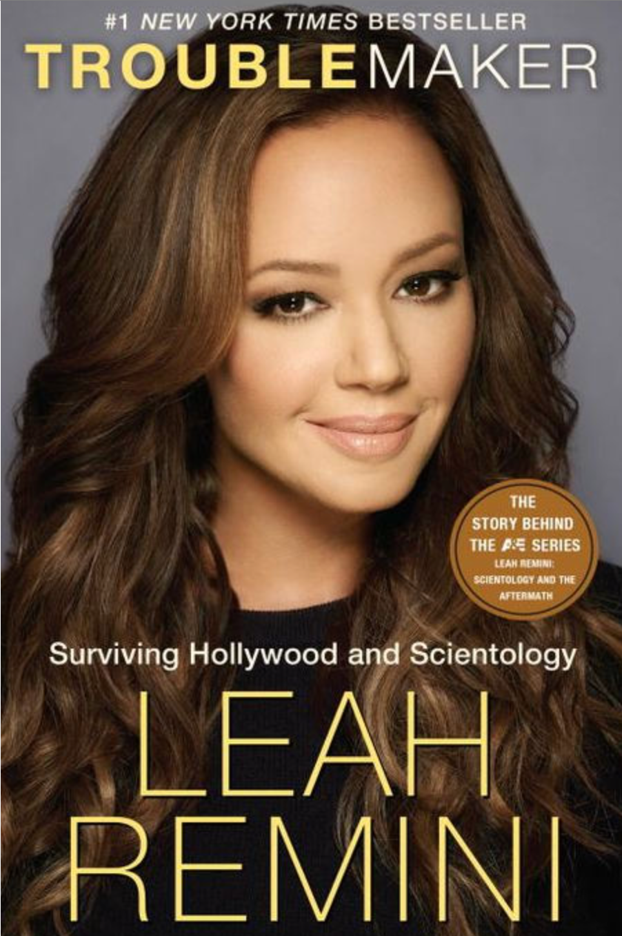 Cover of "Troublemaker" by Leah Remini, featuring the author with long hair. Text highlights surviving Hollywood and Scientology