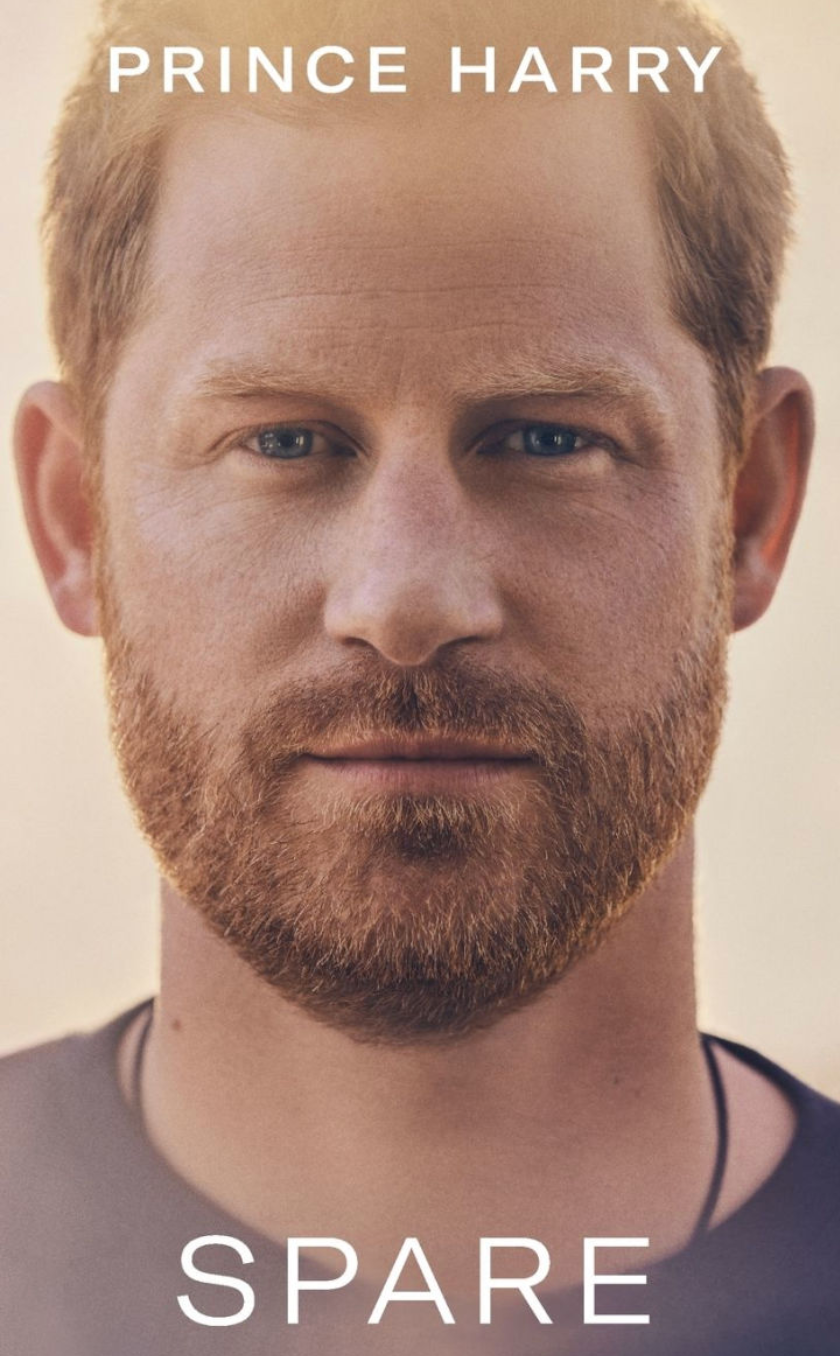 Close-up of a book cover featuring a man with short hair and a beard. Title: "Spare" by Prince Harry