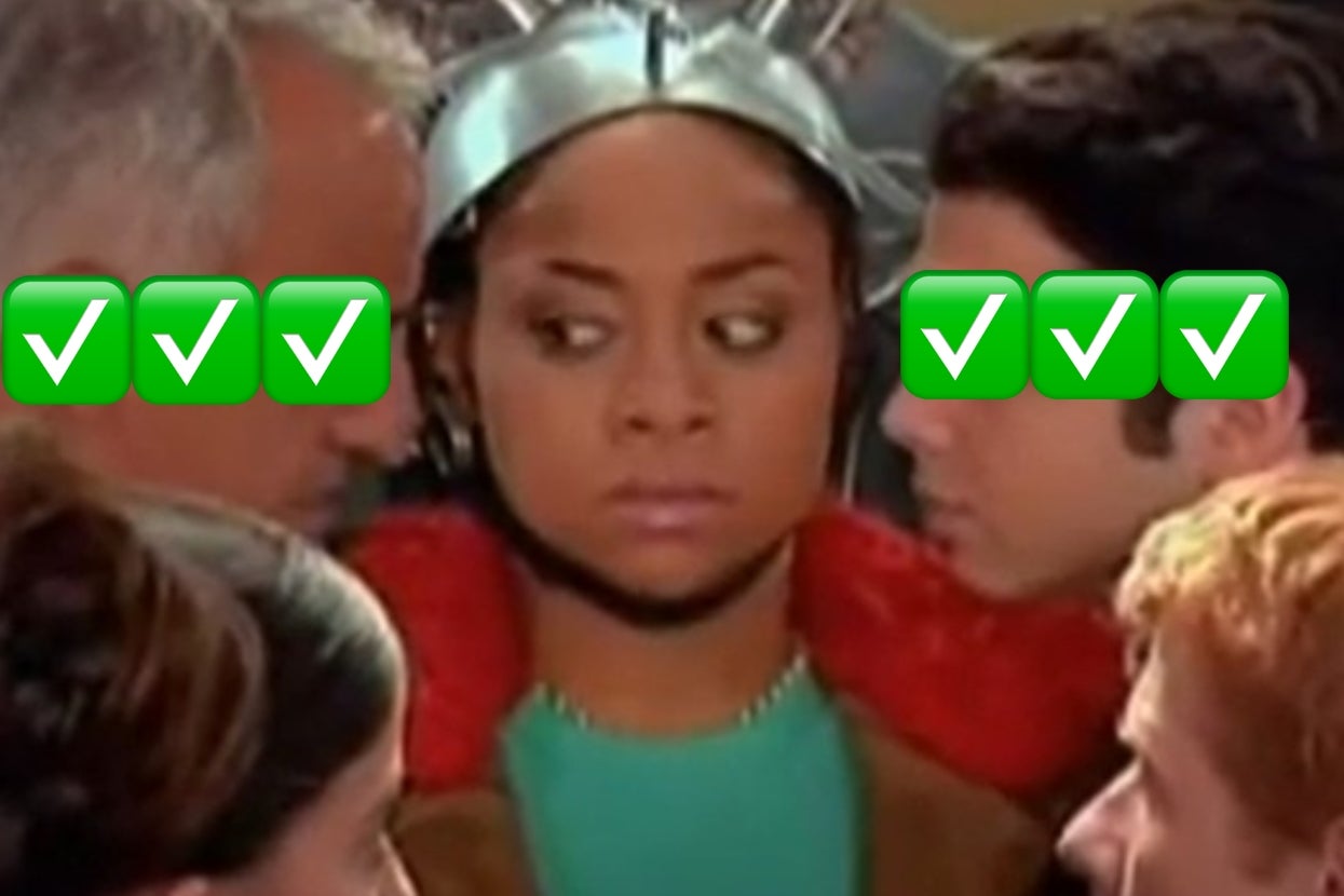 A person wearing a futuristic headpiece looks uneasy surrounded by three people, with green check emojis covering their eyes