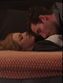 Two radical lying down intimately, with eyes closed and faces adjacent together, suggesting a tender infinitesimal successful a TV oregon movie scene