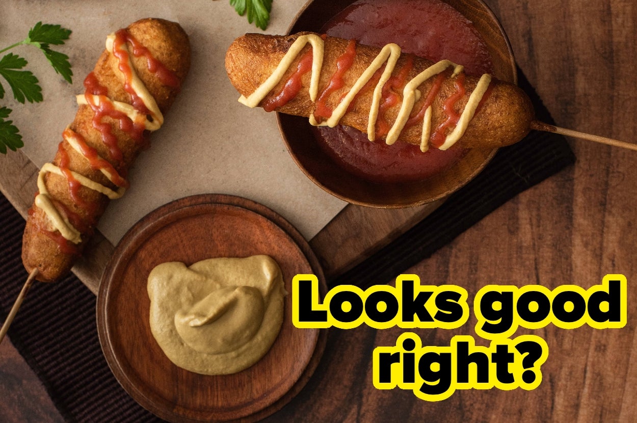 Two corn dogs with mustard and ketchup, one on a skewer dipping in sauce. Text reads: "Looks good right?"