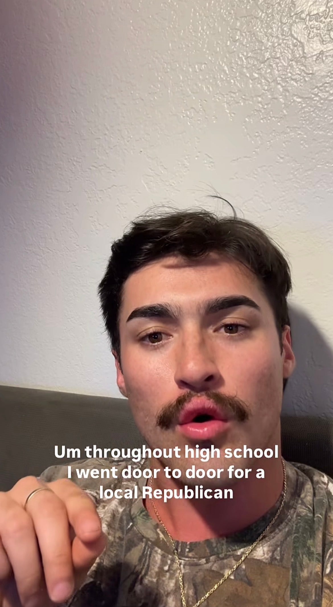 Person with a mustache speaks in a selfie. Text on image: "Um throughout high school I went door to door for a local Republican."