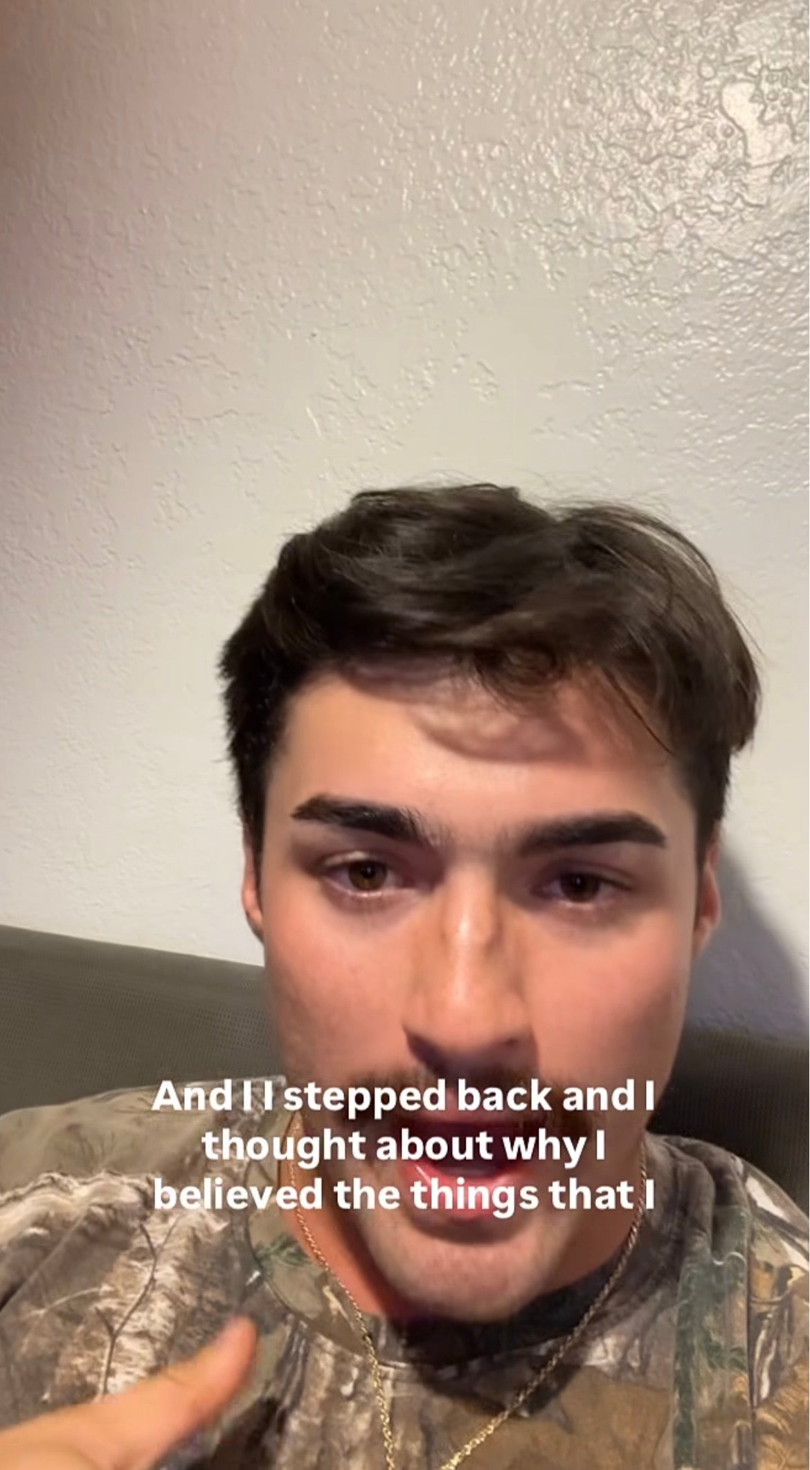 A person wearing a camo shirt is speaking in a casual setting. Text on the image reads, "And I stepped back and I thought about why I believed the things that I..."