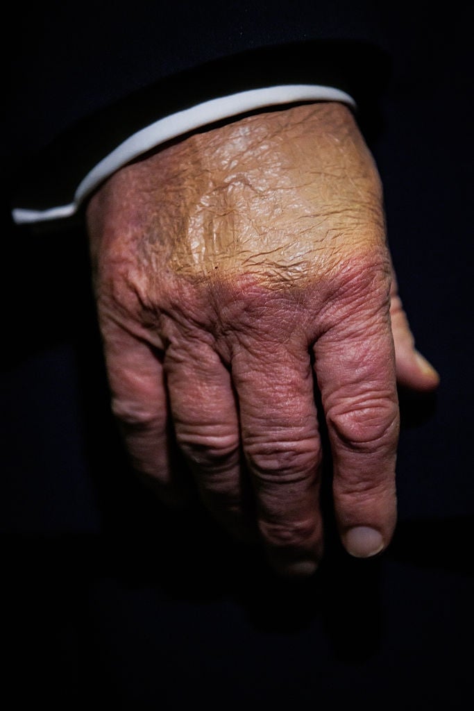 Close-up of an older adult's hand resting naturally, displaying detailed skin texture and slight wrinkles