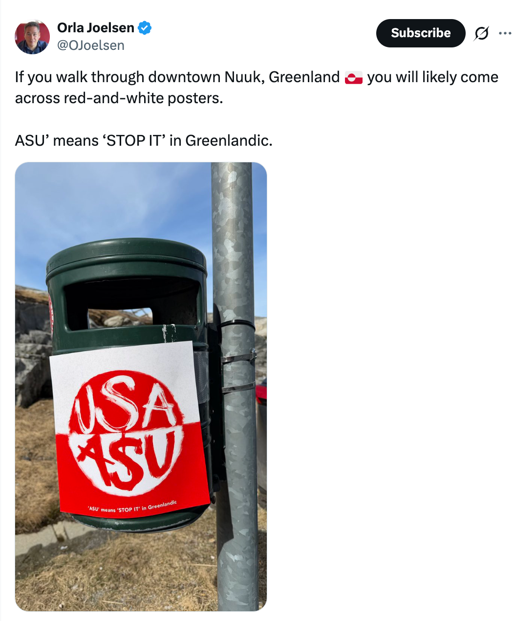 Tweet shows a poster on a bin in Nuuk, Greenland, reading "USA ASU." Caption explains "ASU" means "STOP IT" in Greenlandic