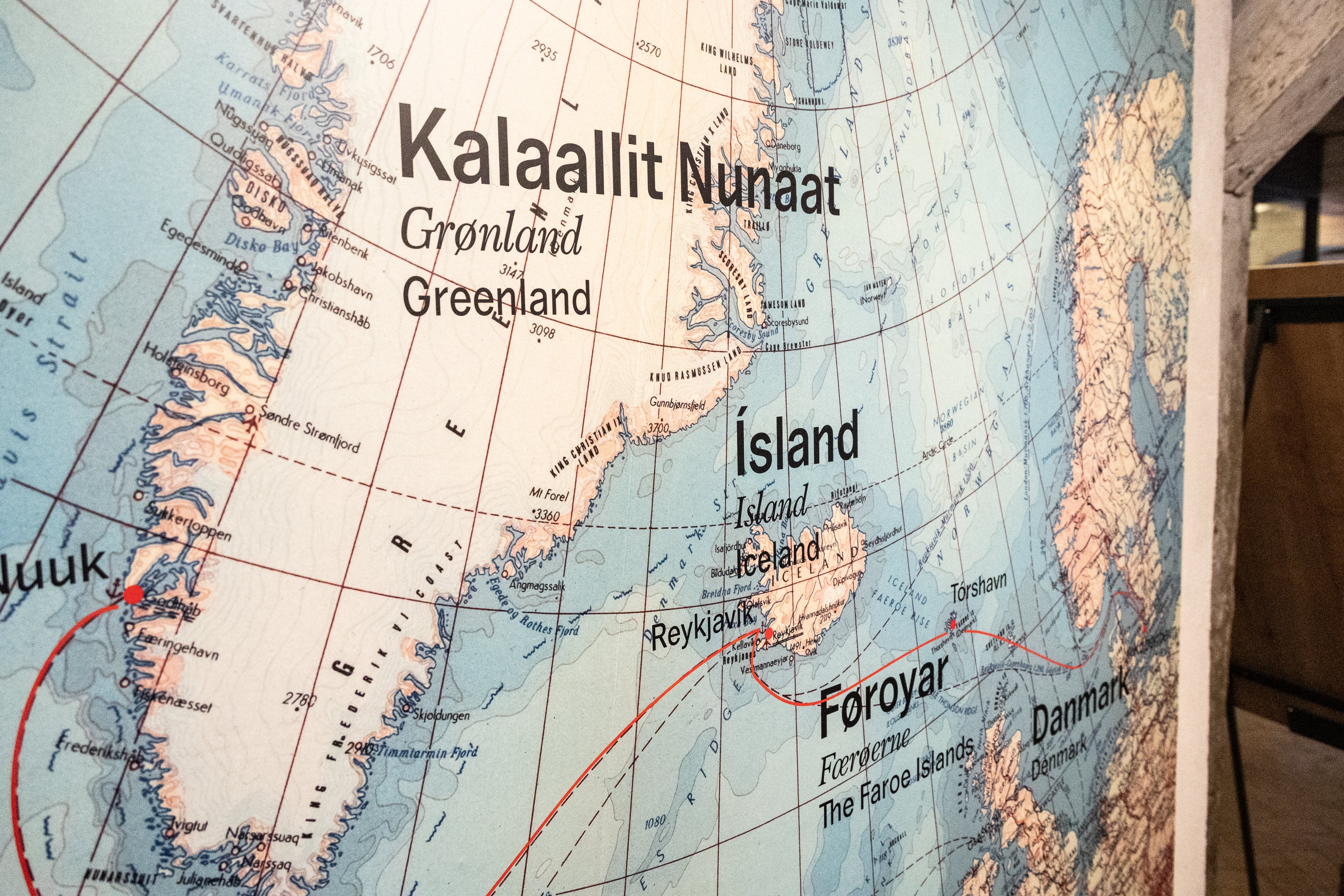Close-up of a world map focusing on Greenland, Iceland, and the Faroe Islands, highlighting their geographical positioning