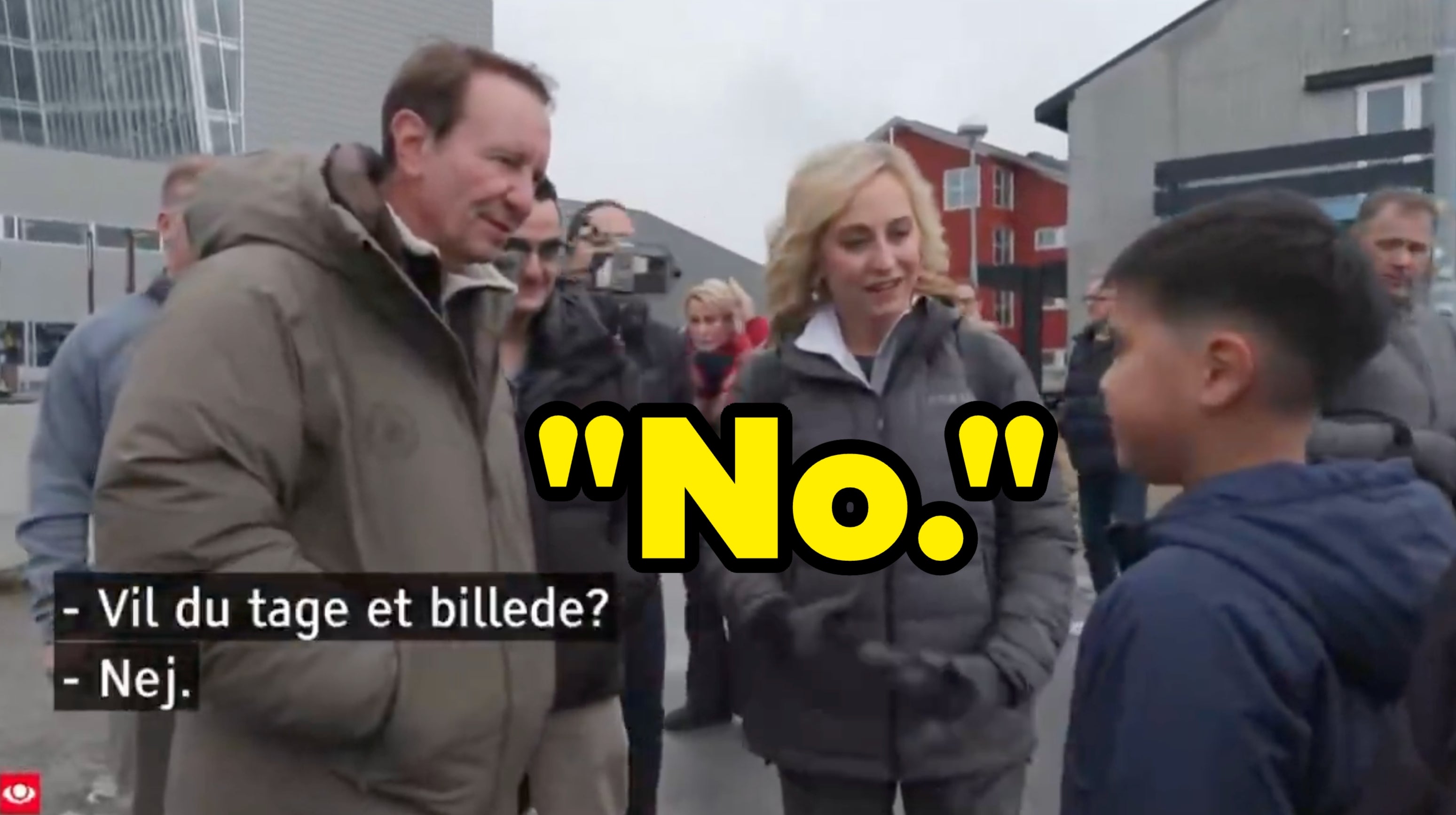 People in winter clothing interact outdoors; a child responds "No" to a photo request in subtitles