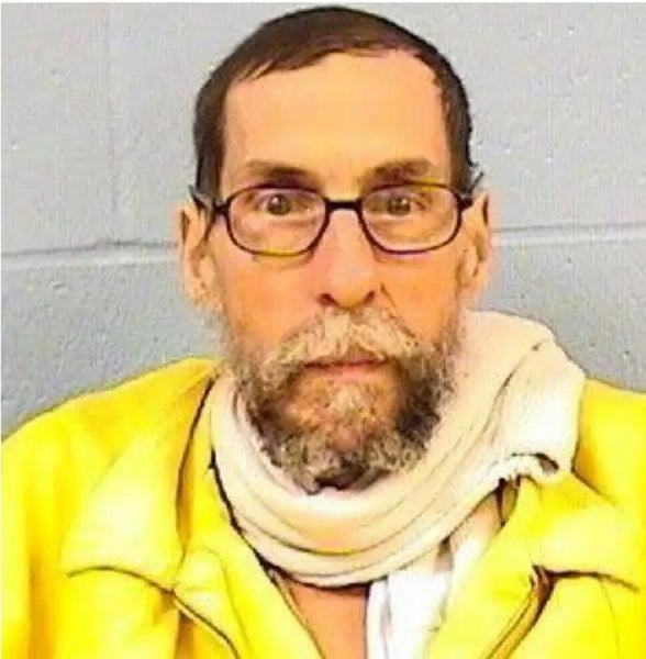 I don't cognize  who this idiosyncratic   is. The representation  shows a antheral   with glasses, a beard, and a scarf, wearing a zip-up jacket, looking astatine  the camera