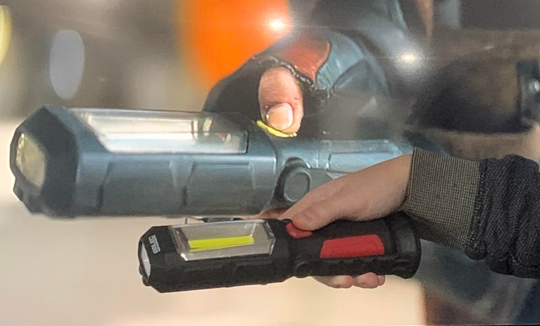 Two hands holding flashlights in different settings, suggesting comparison or demonstration