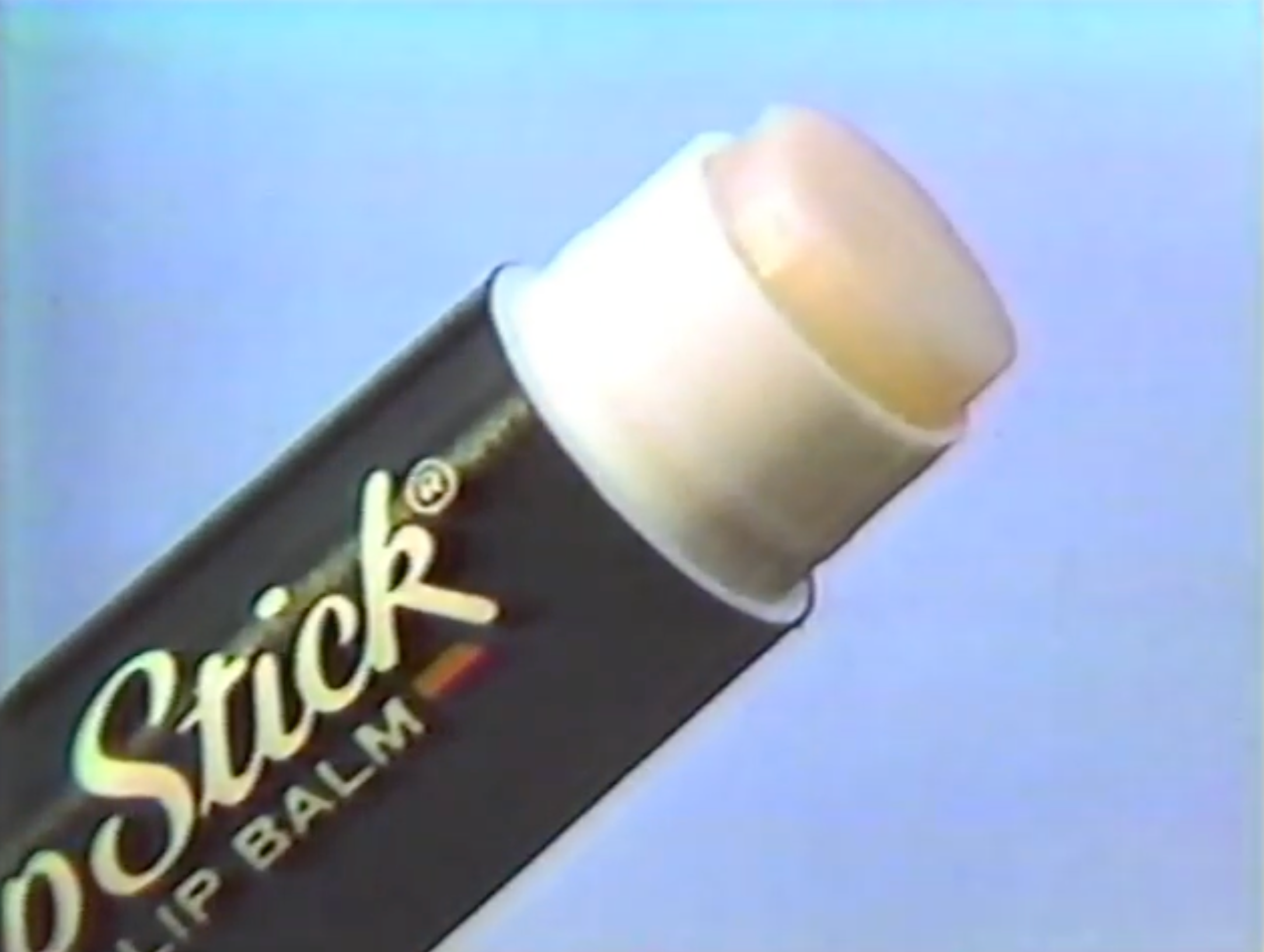 Close-up of a ChapStick lip balm tube partially extended, against a plain background