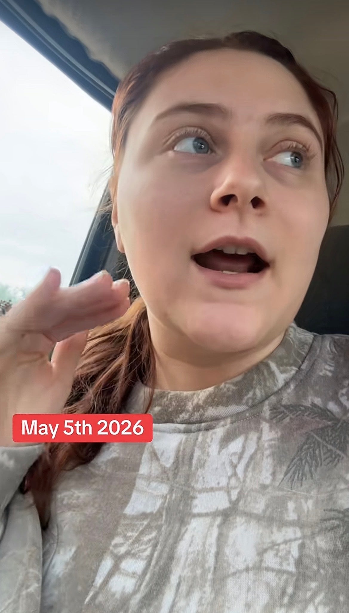 Person in a patterned top speaking in a car, with date "May 5th, 2026" displayed onscreen