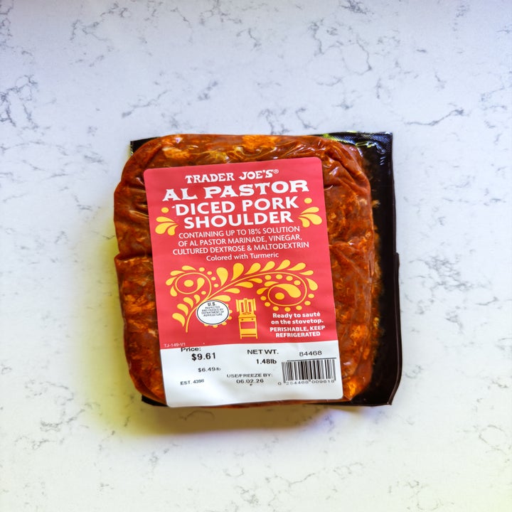 Package of Trader Joe's Al Pastor Diced Pork Shoulder on a marble surface