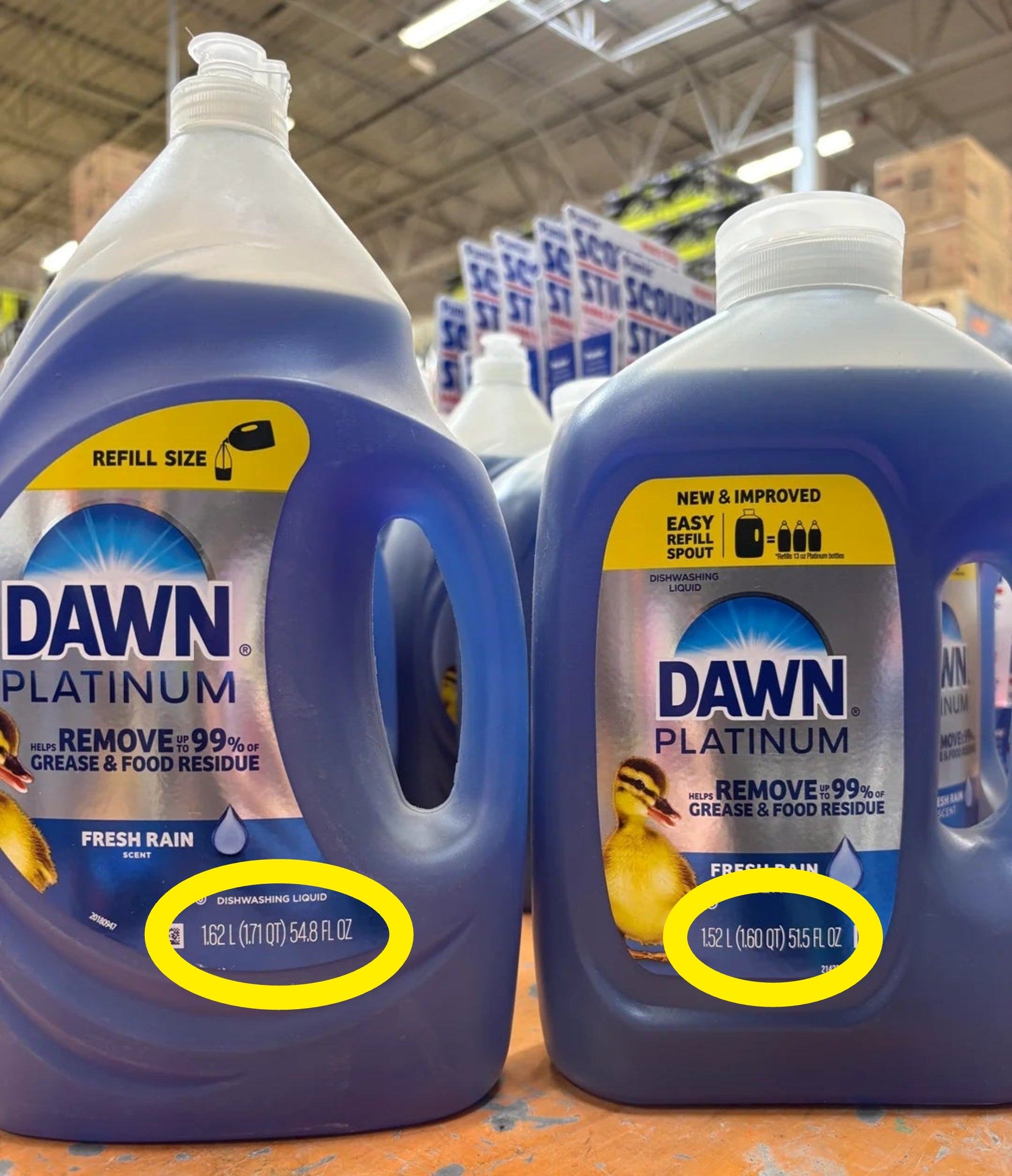 Two ample  Dawn Platinum crockery  soap bottles labeled "Fresh Rain" scent connected  a store   shelf