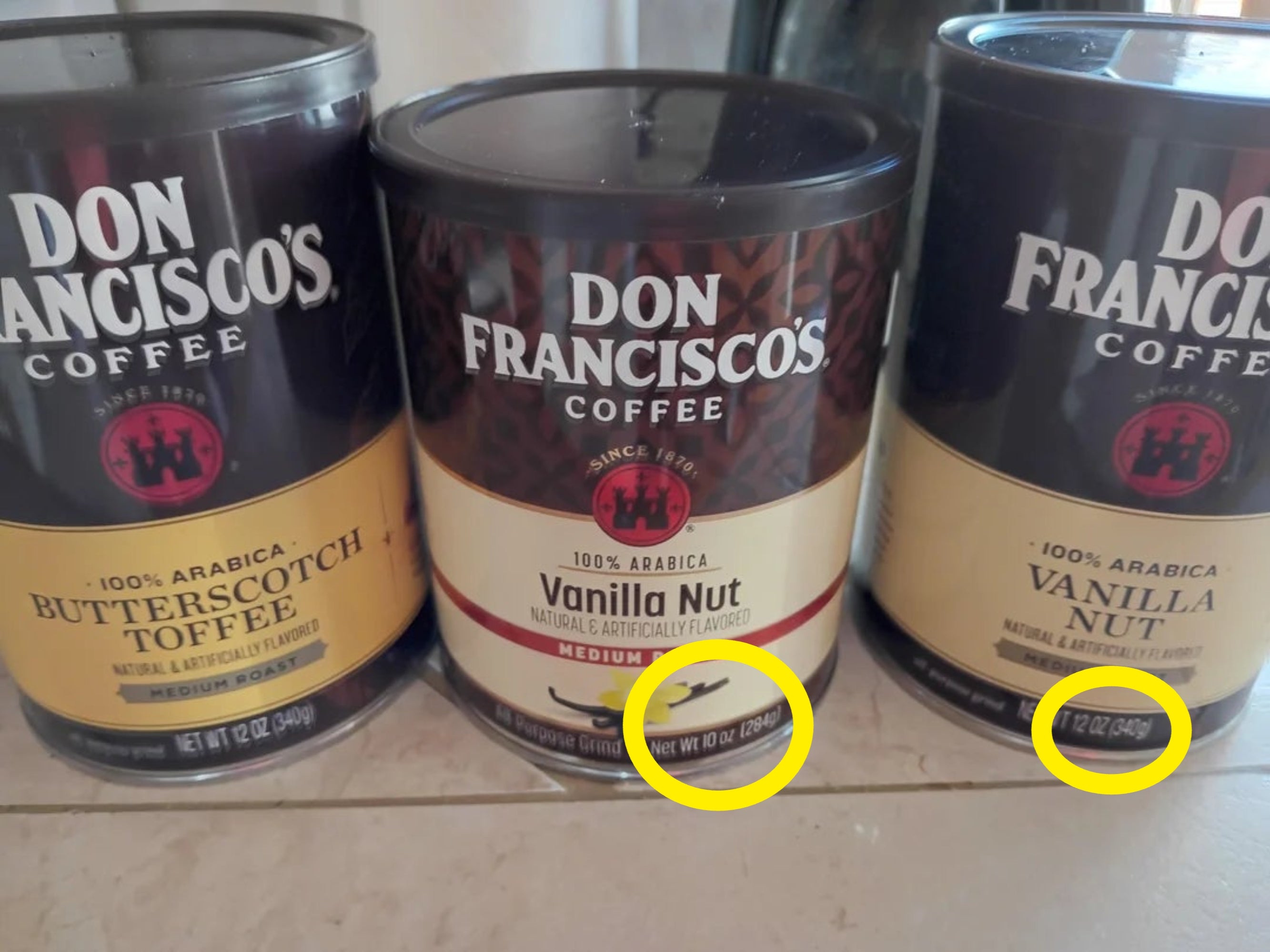 Three cans of Don Francisco's Coffee: Butterscotch Toffee and Vanilla Nut mean   roast flavors