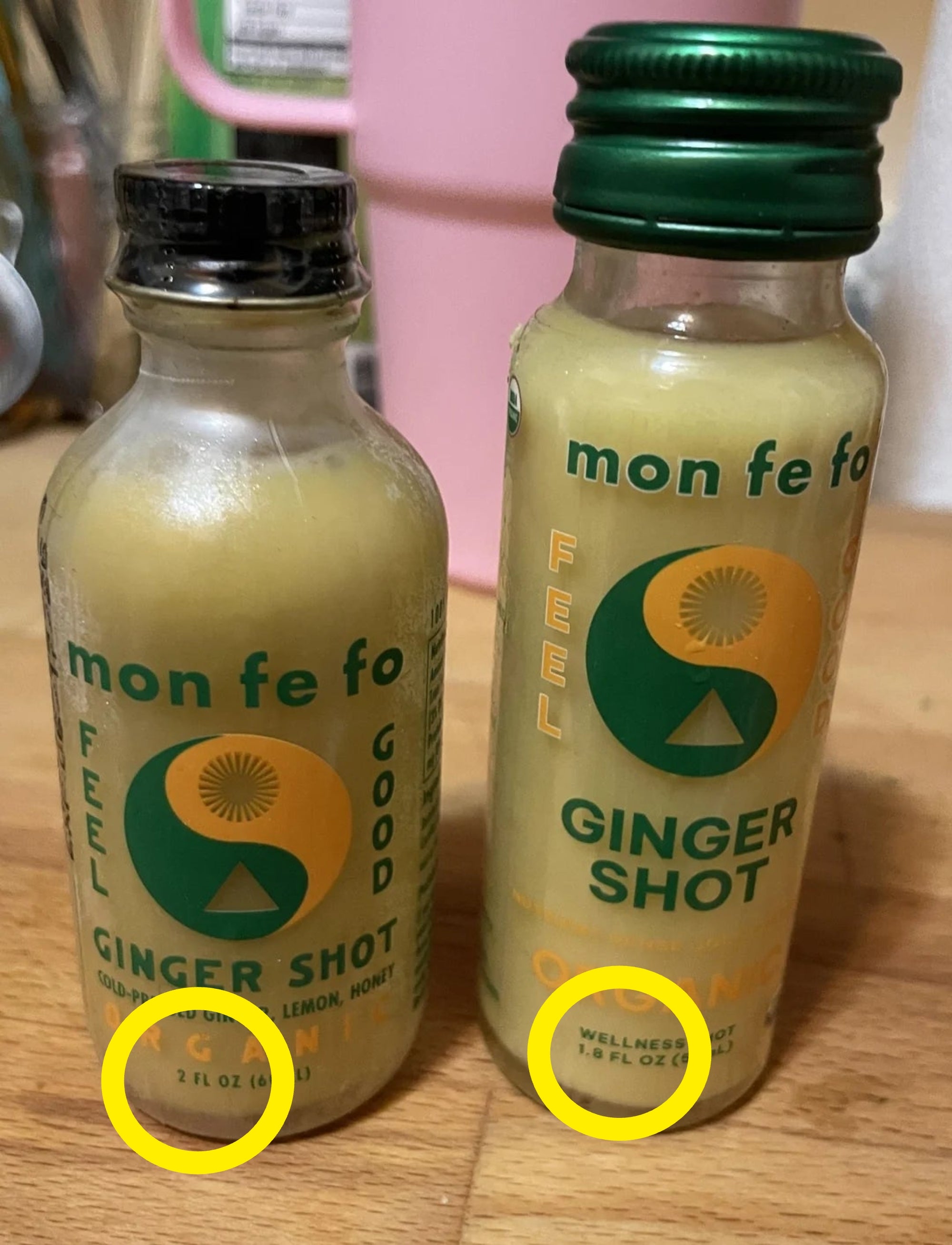 Two bottles of ginger changeable  labeled "mon fe fo" with substance   "Feel Good" and "Ginger, Lemon, Honey"
