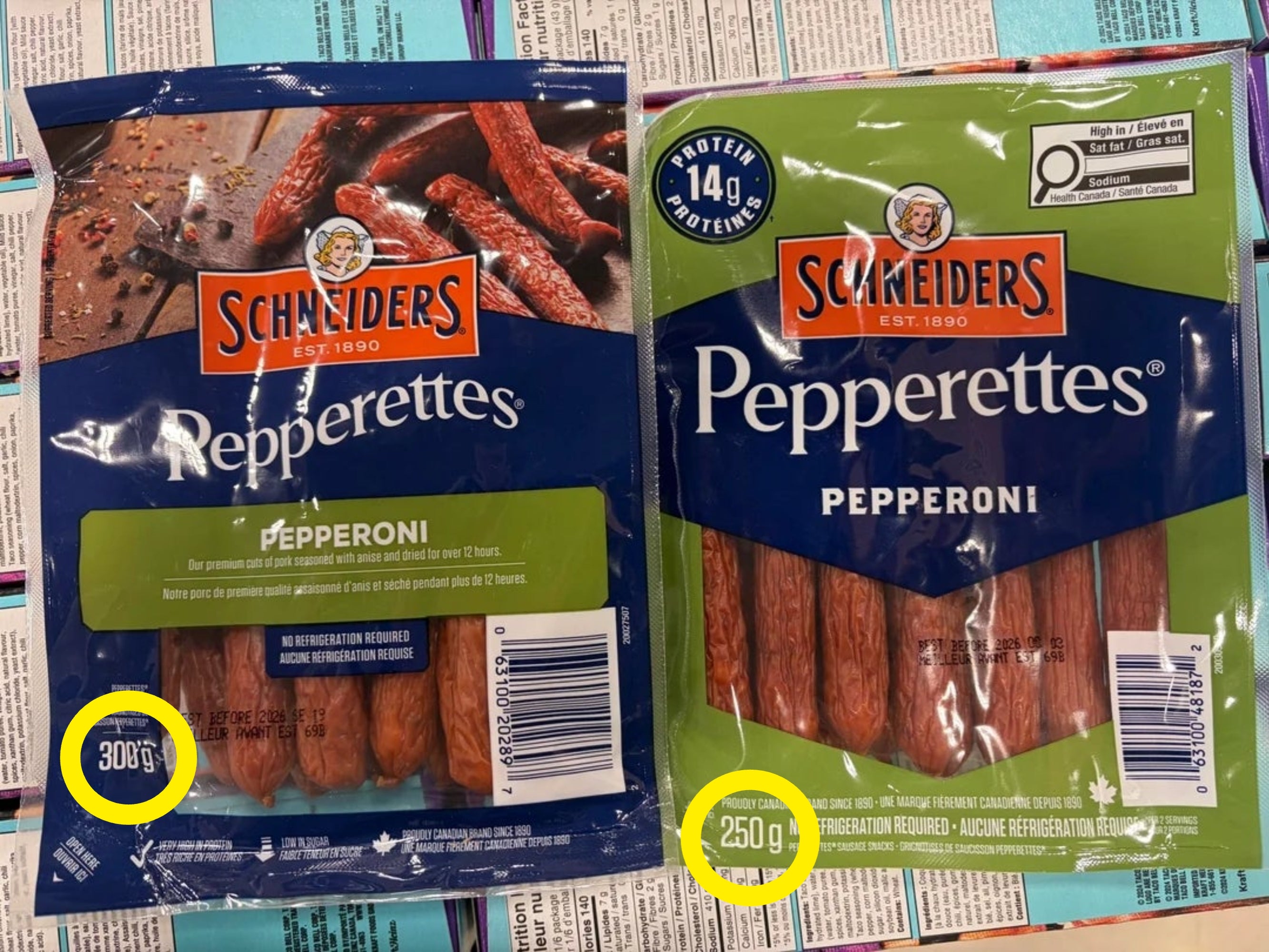 Two packages of Schneiders Pepperettes, labeled arsenic  pepperoni snacks, are displayed broadside  by broadside  connected  a store   shelf