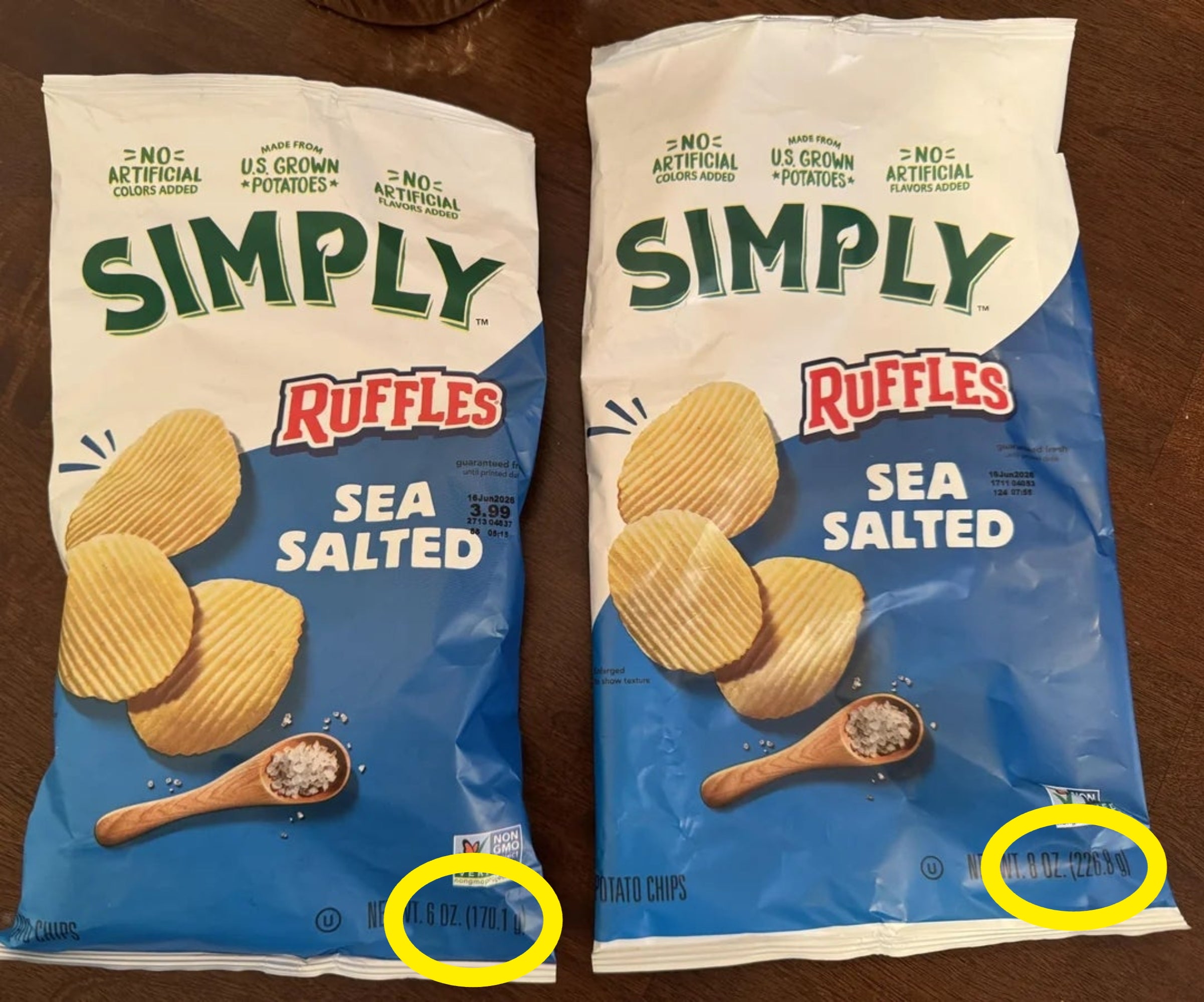 Two bags of Simply Ruffles Sea Salted murphy  chips are shown connected  a table