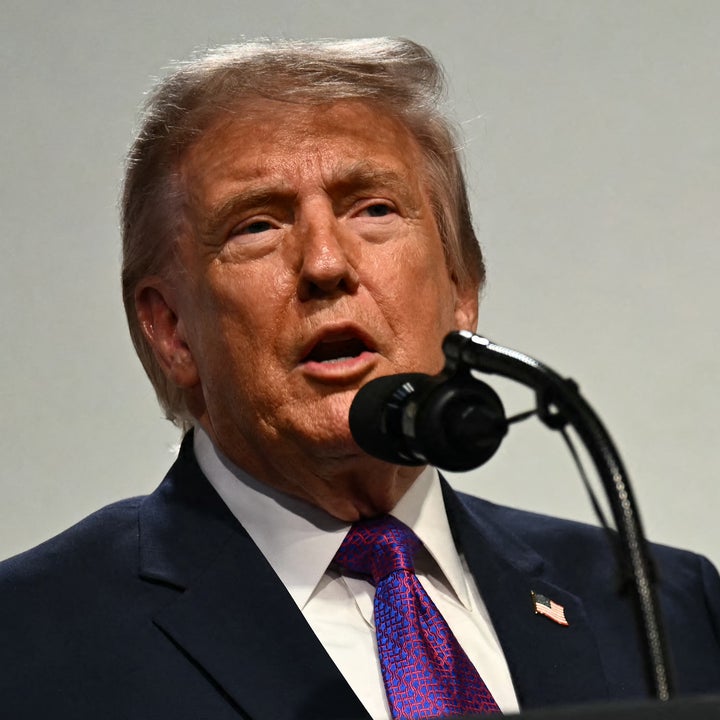 A person is speaking at a podium with the U.S. presidential seal
