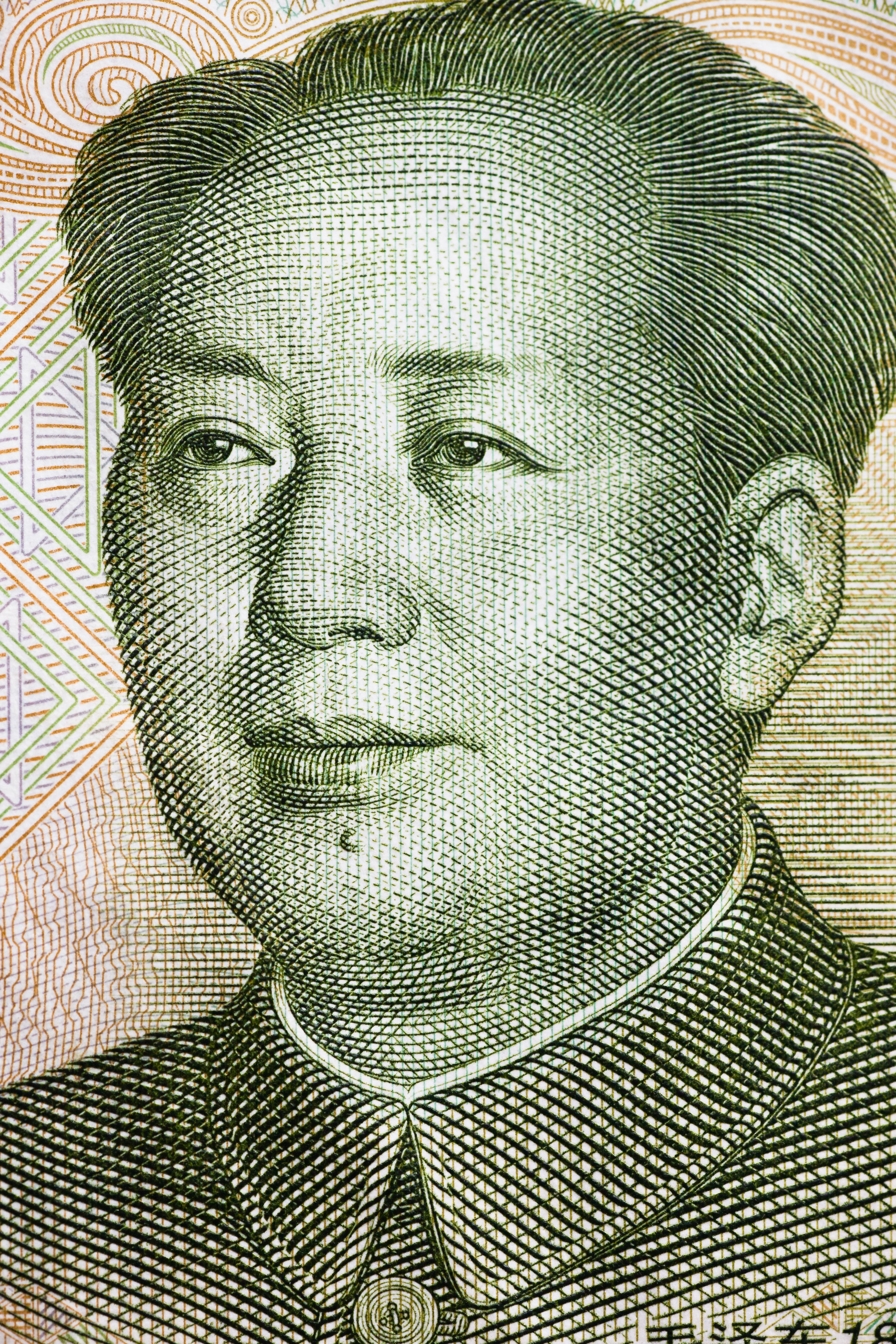 Portrait of a person with short hair and a collared shirt, appearing on currency-style design