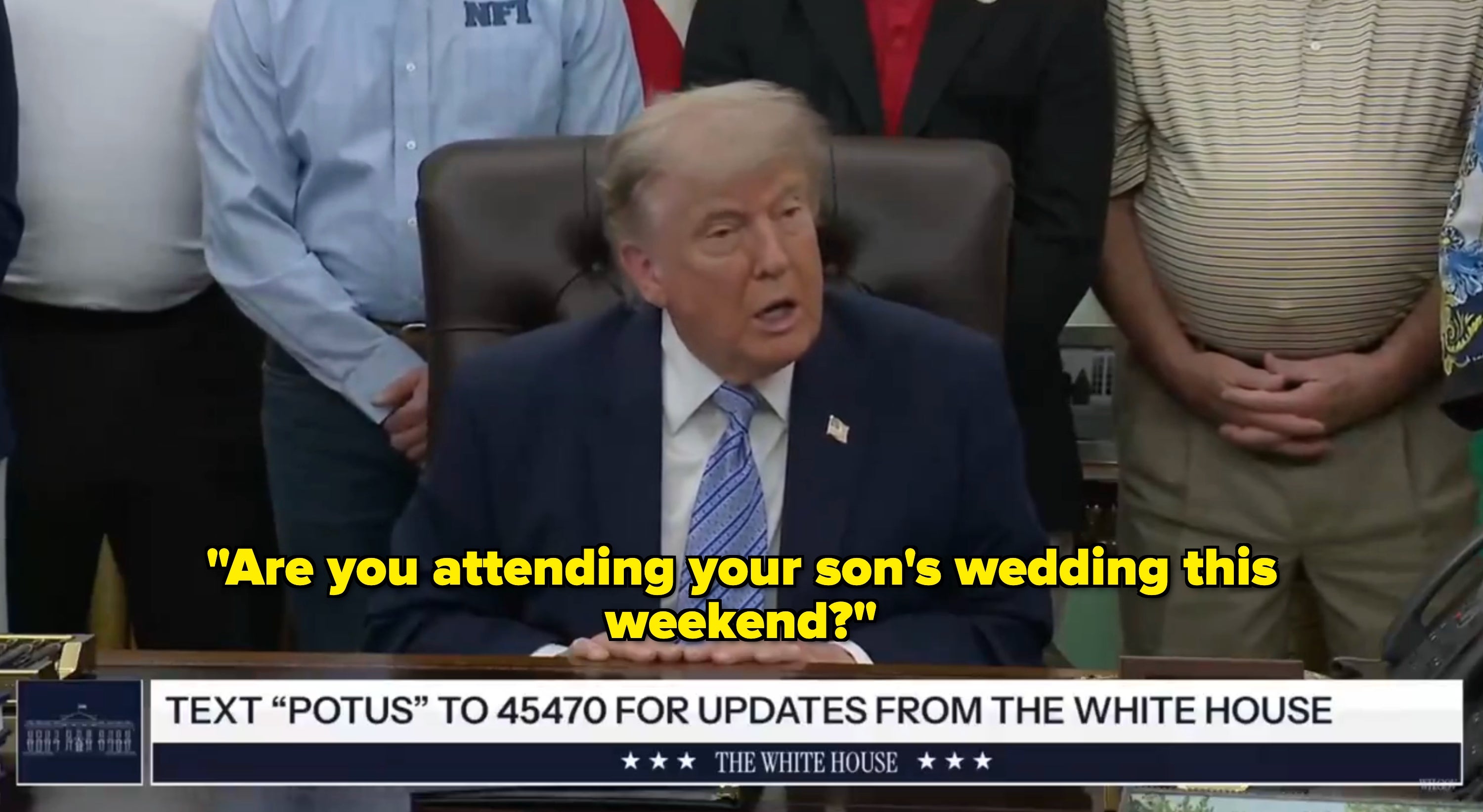 A idiosyncratic   seated astatine  a table  speaks to a group; a connection   on-screen invites viewers to substance   for updates from the White House
