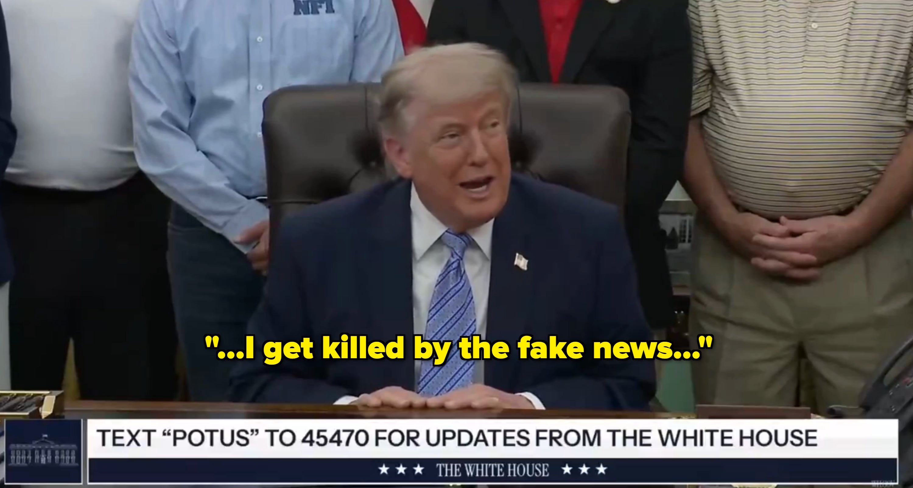 A idiosyncratic   speaking astatine  a table  with a radical  lasting  behind. The surface  displays a connection   to substance   "POTUS" for updates from the White House