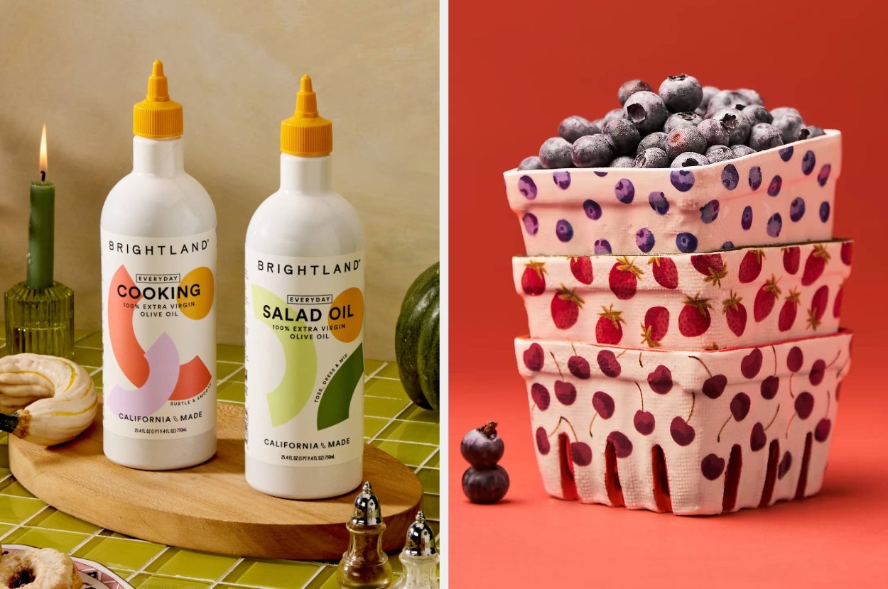 Brightland cooking and salad oils placed on a wooden tray next to berry-patterned bowls stacked, filled with blueberries