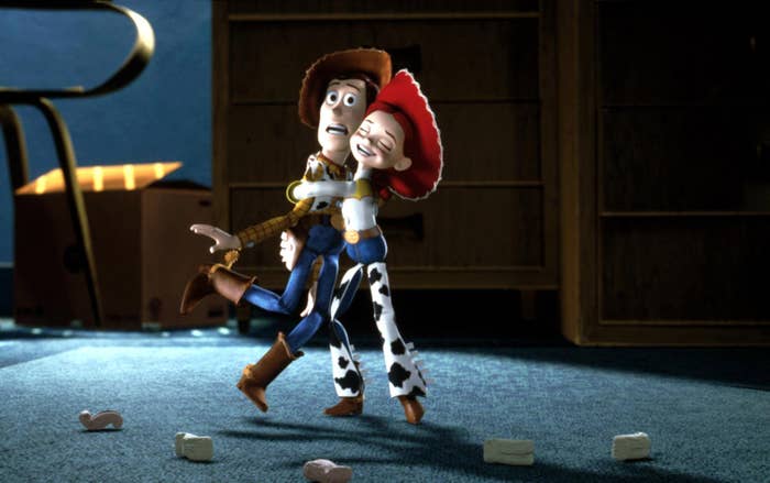 Woody and Jessie from Toy Story joyfully dancing in a playful scene with blocks scattered on the floor