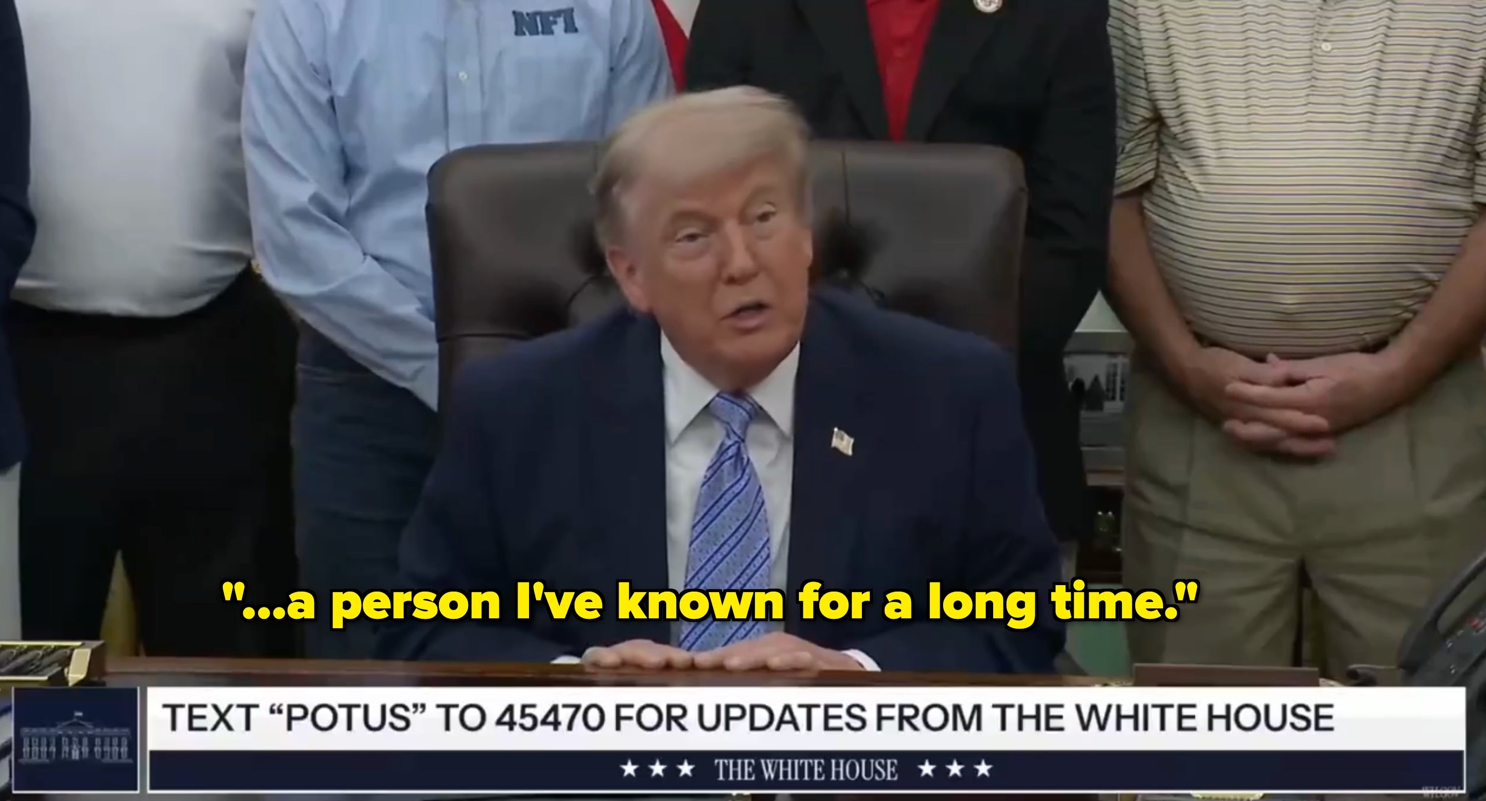 A person sits at a desk, speaking in a meeting. A banner reads: "Text 'POTUS' to 45470 for updates from the White House."