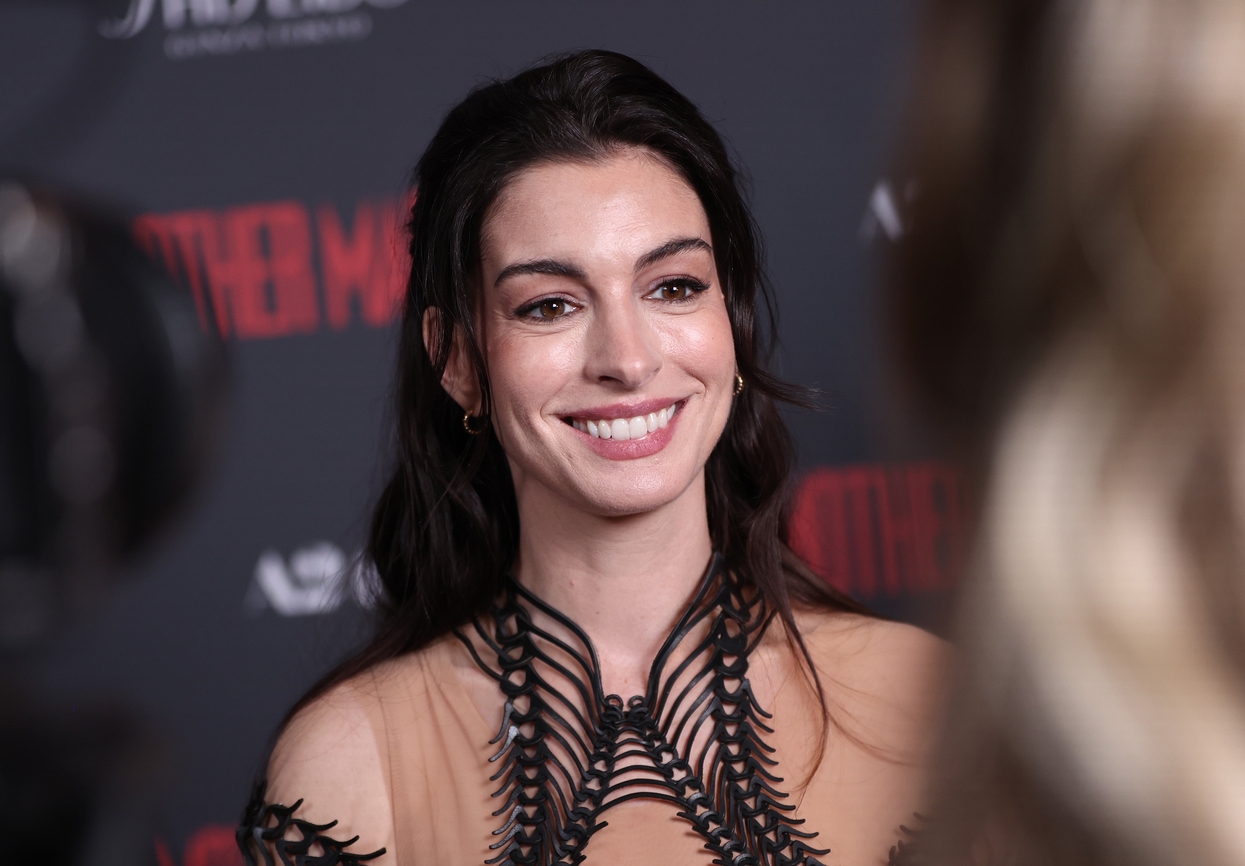 Celebrity connected reddish carpet successful intricately designed dress, smiling astatine event
