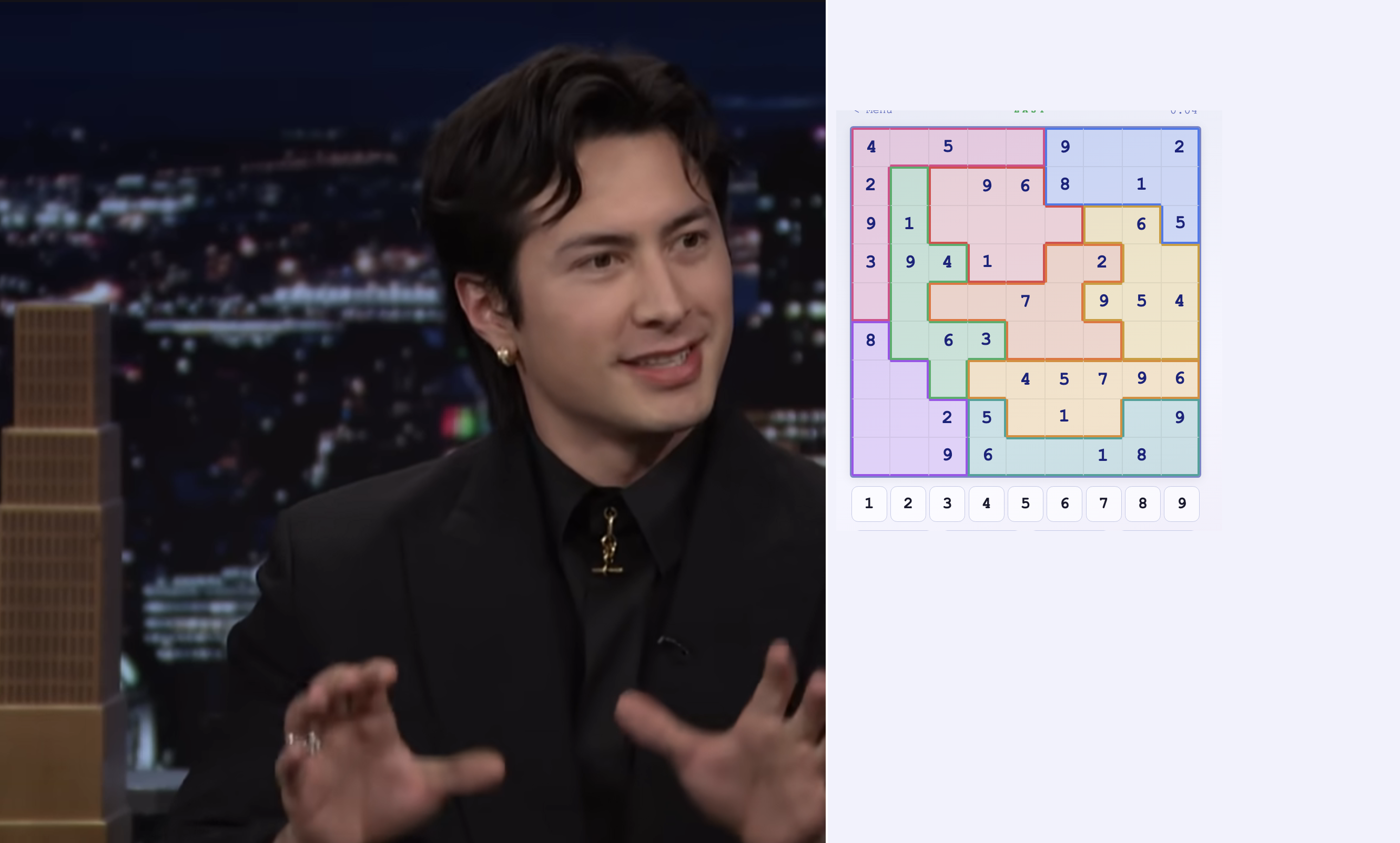 Person gesturing on a talk show; next to them, a Sudoku puzzle is partially completed