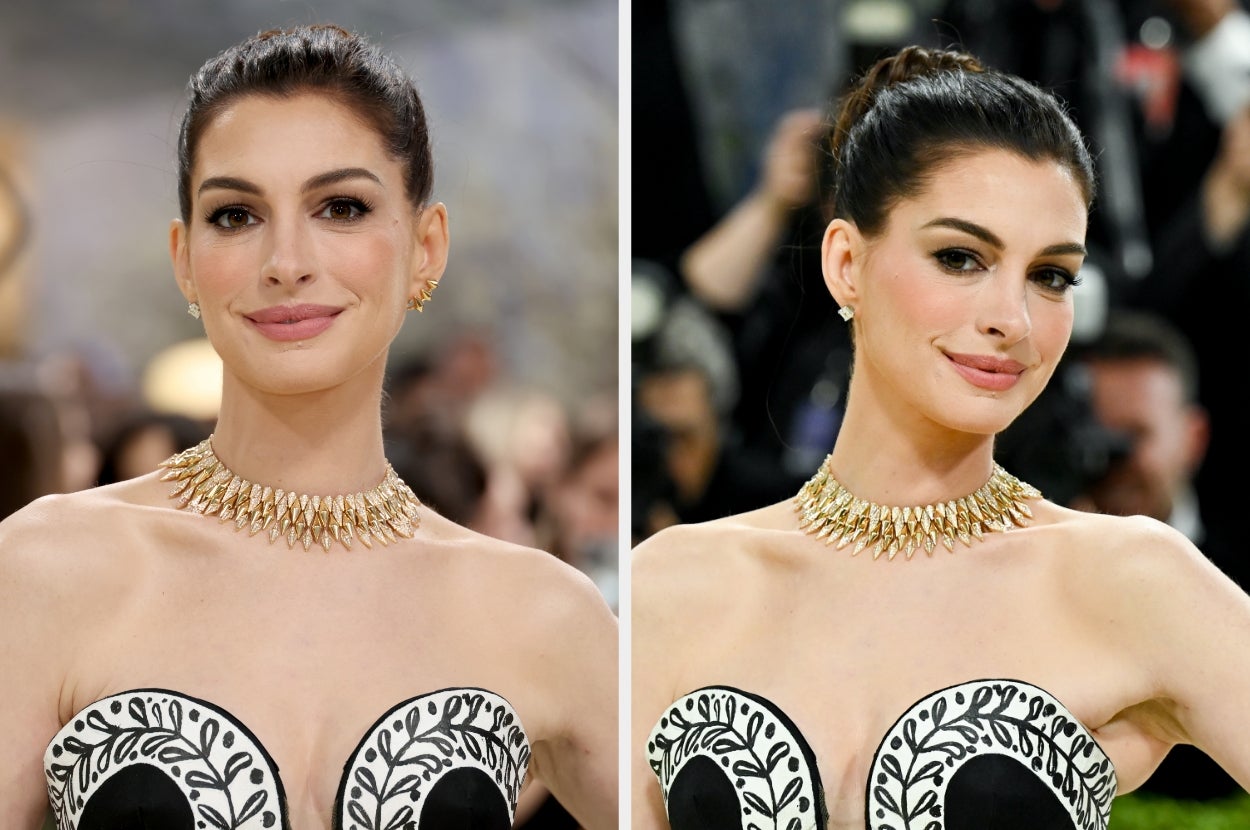 A woman on a red carpet wearing a strapless dress with intricate detailing and a statement necklace