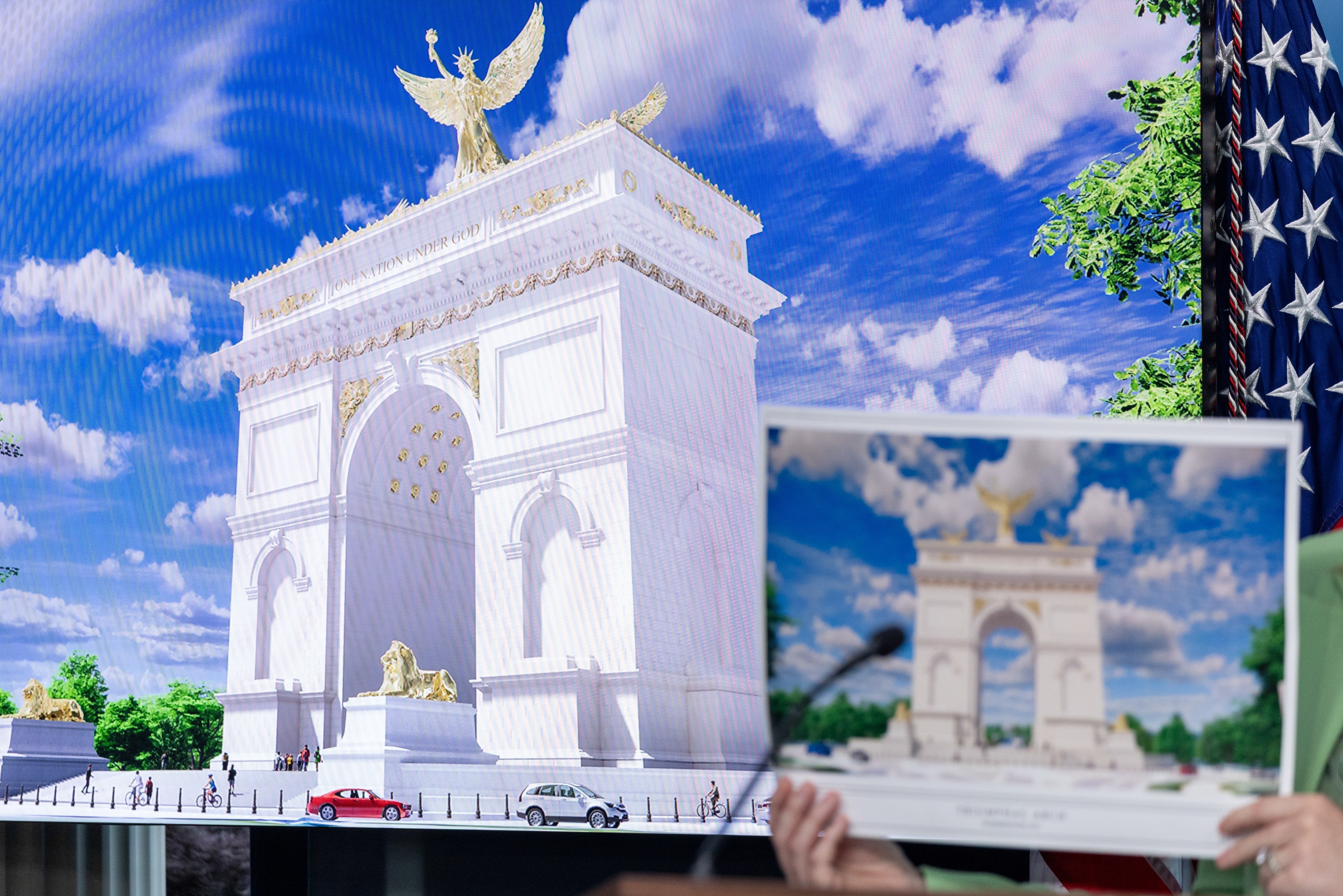 Person holding an representation of the Arc de Triomphe successful beforehand of a surface displaying the aforesaid monument