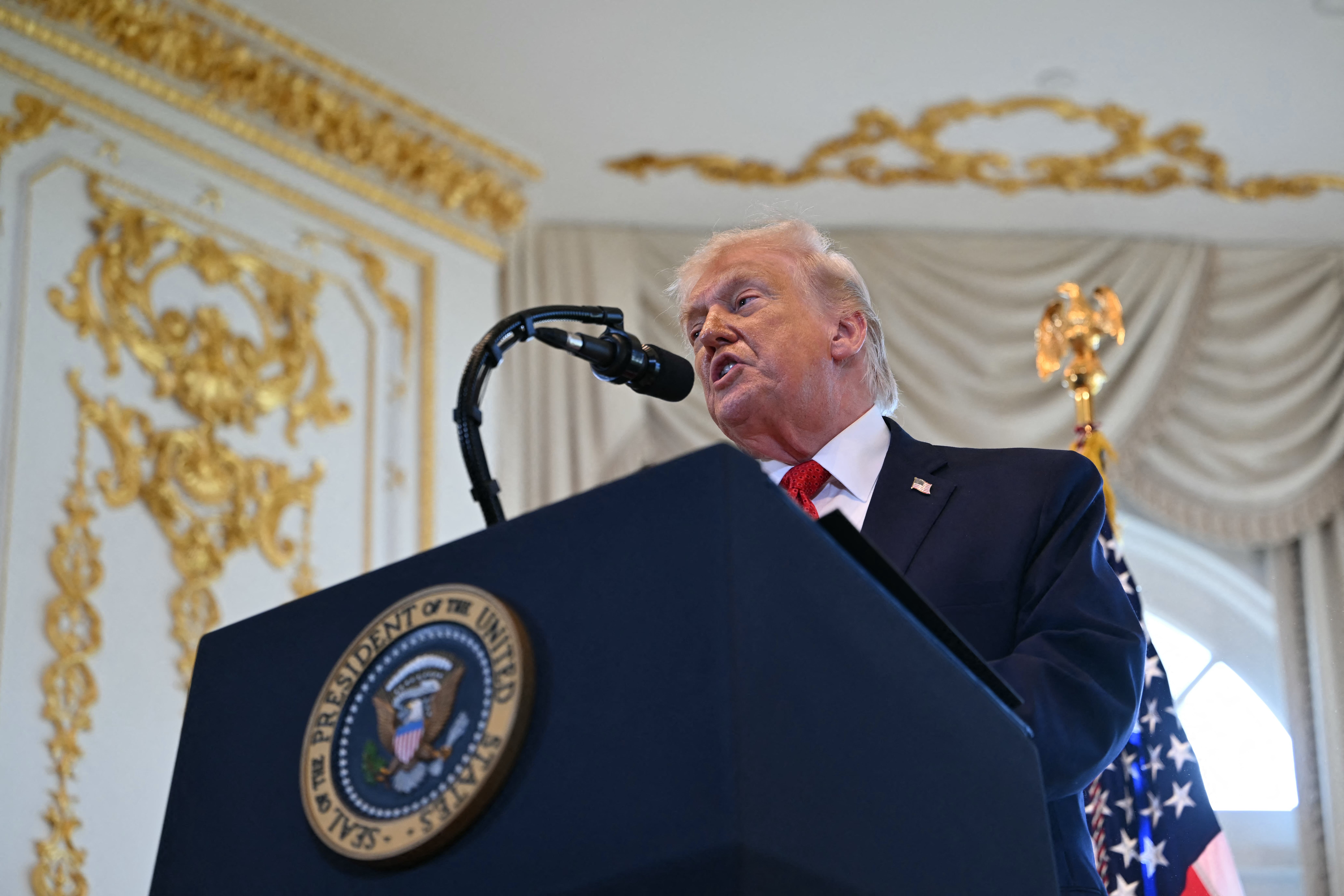 Person speaking astatine a podium with a "President of the United States" emblem, U.S. emblem successful the background